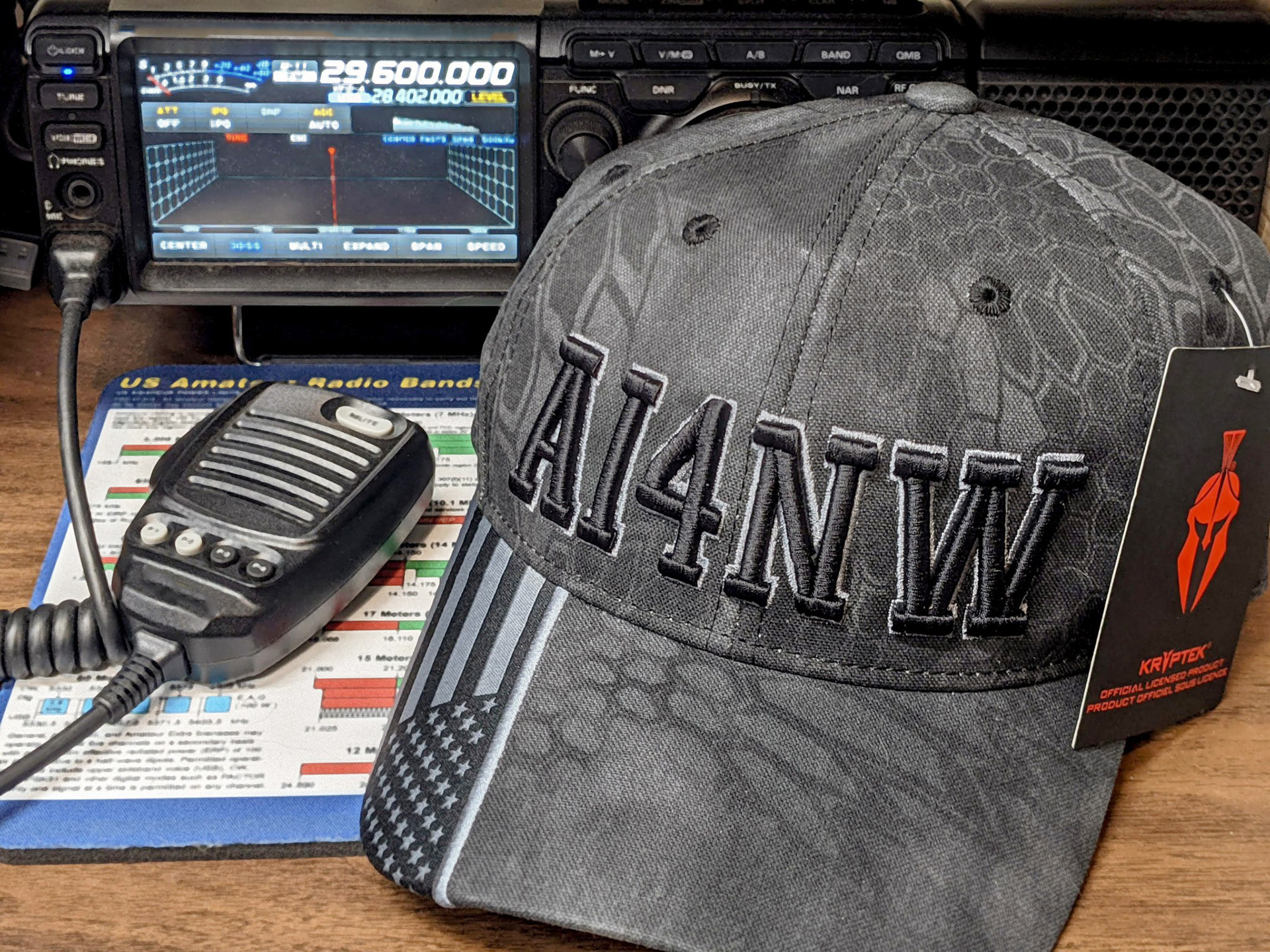 Custom embroidered ham radio call sign hat displayed with amateur radio equipment