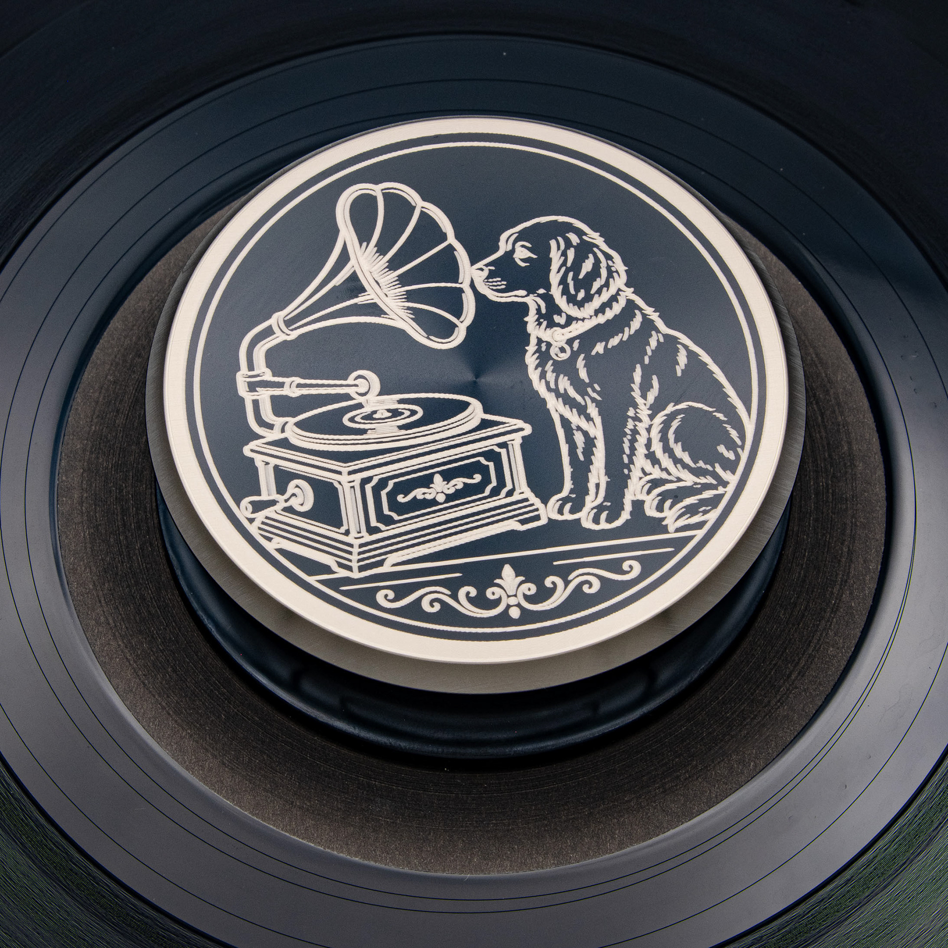 Dog and gramophone engraved vinyl record weight stabilizer shown on a turntable for vintage audio collectors