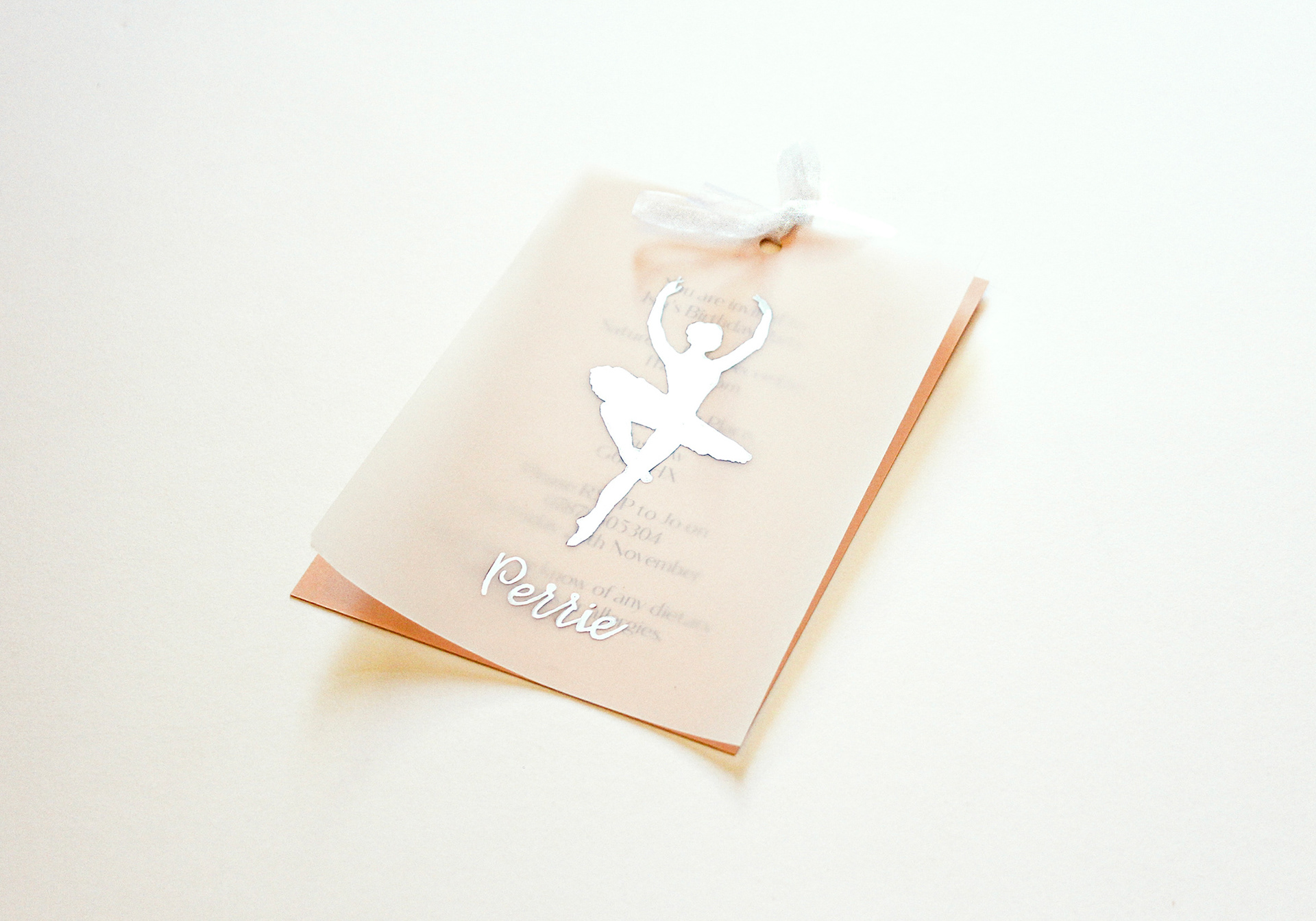 party invite design - ballerina theme birthday party invite. on the top there is a dancing ballerina drawn on to velum paper with a girls name written below , underneath there is a soft peach page with the details of the party. both are joined together with white ribbon at the top.