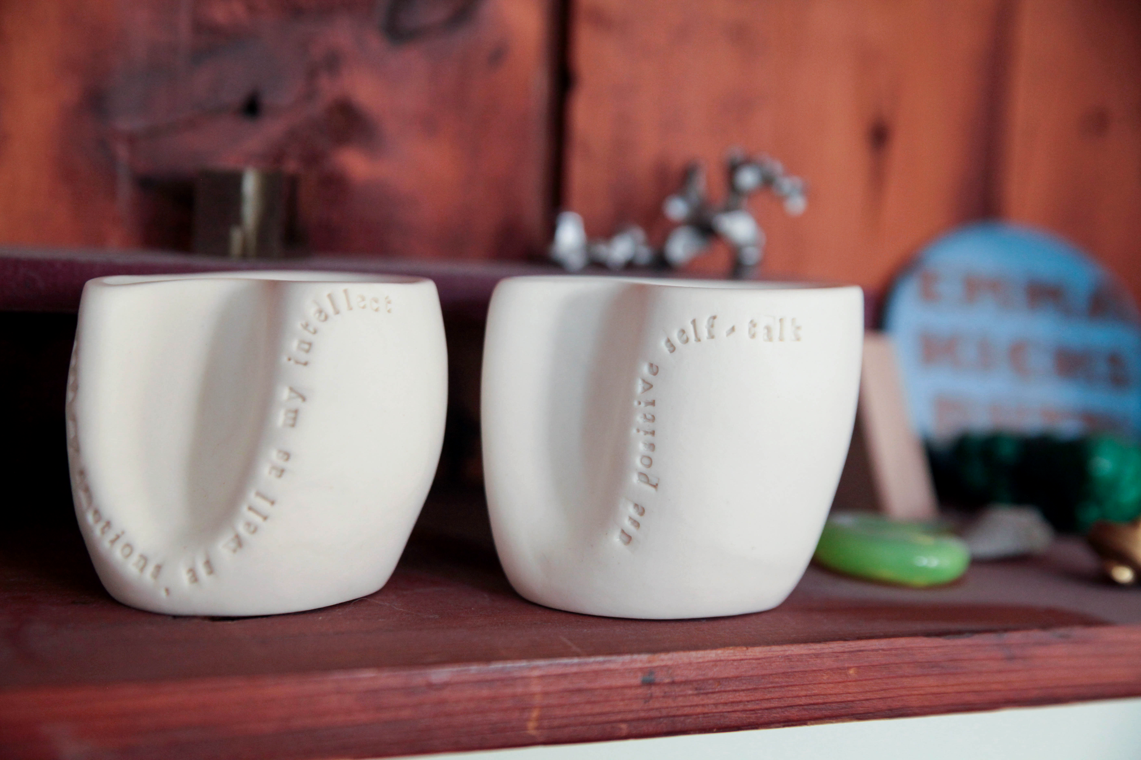 Two cups are placed on a shelf in the community member’s home to demonstrate that this individual has agreed to complete these acts of kindness