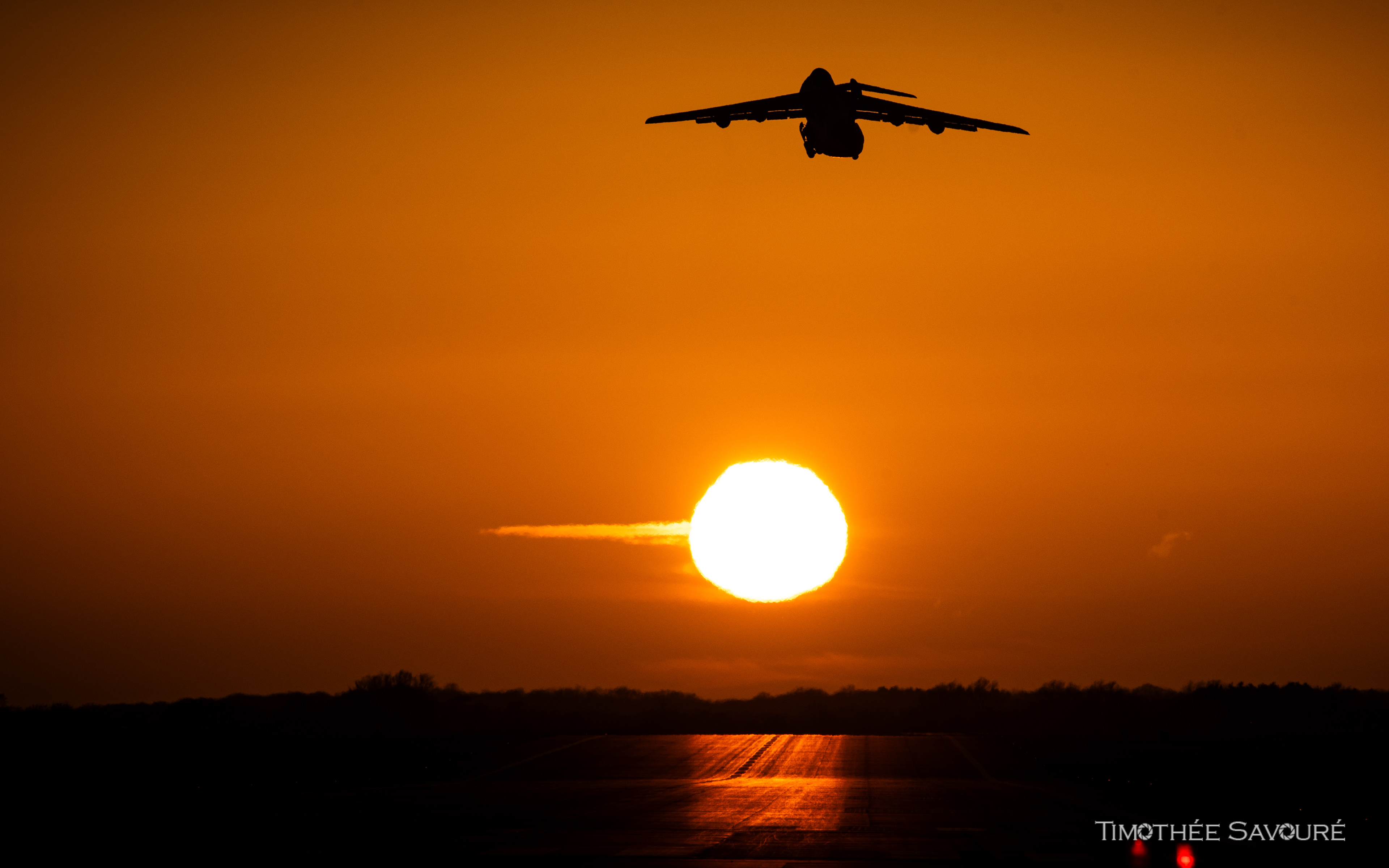 C-5 departing in the setting sun