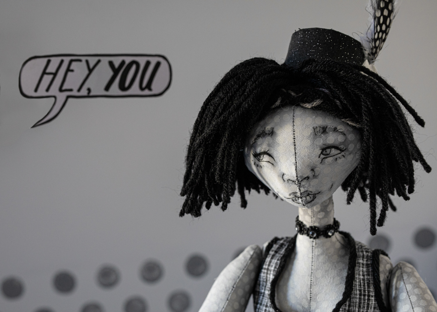 Detail, The Kitchen: black and white doll with speech bubble in background | Maleah Miller