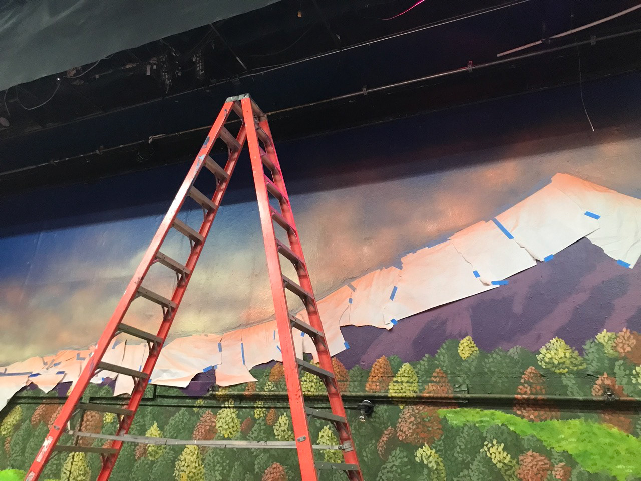 Painting clouds using a high volume low pressure paint sprayer