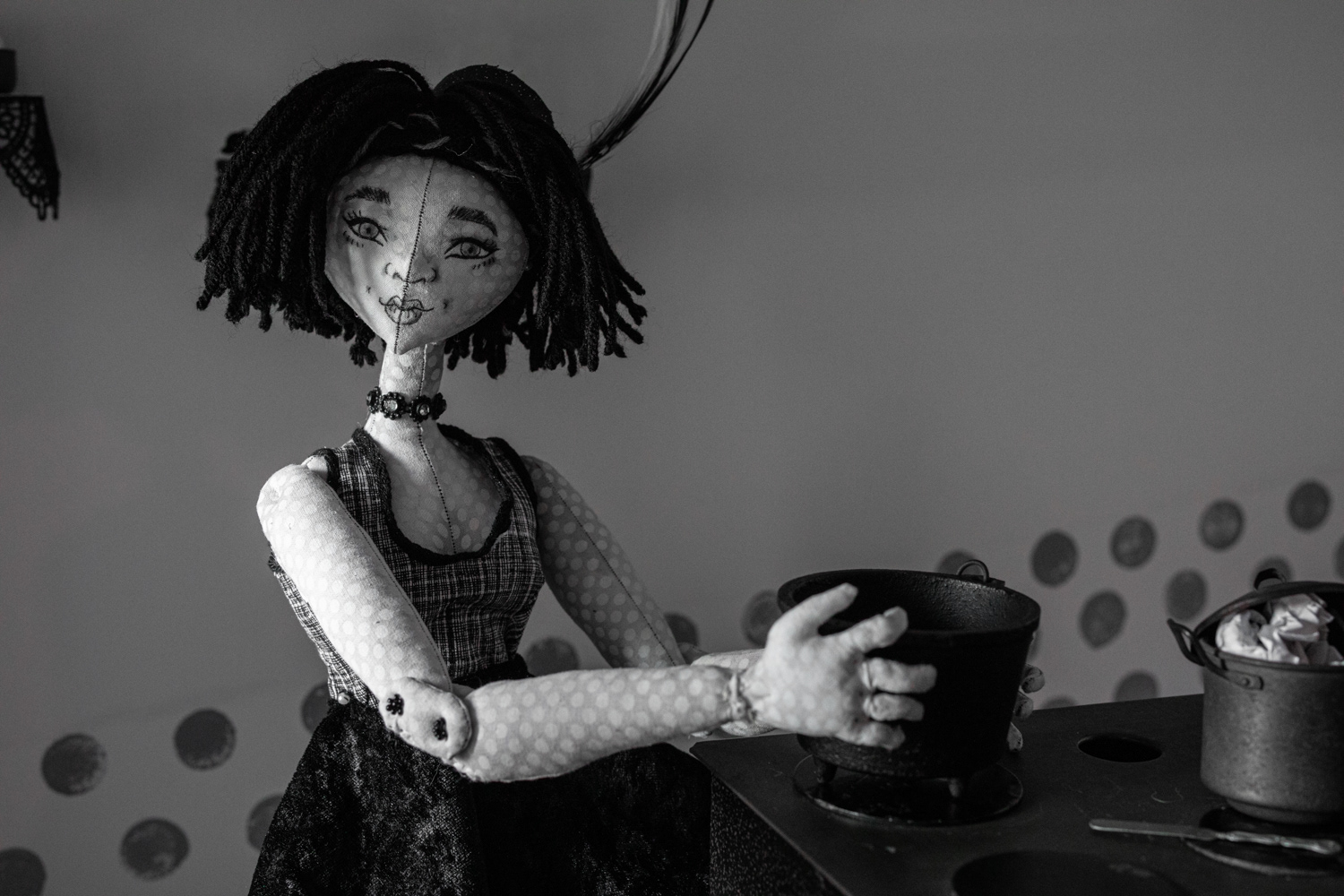Detail, The Kitchen: black and white cloth doll with cooking pot | Maleah Miller