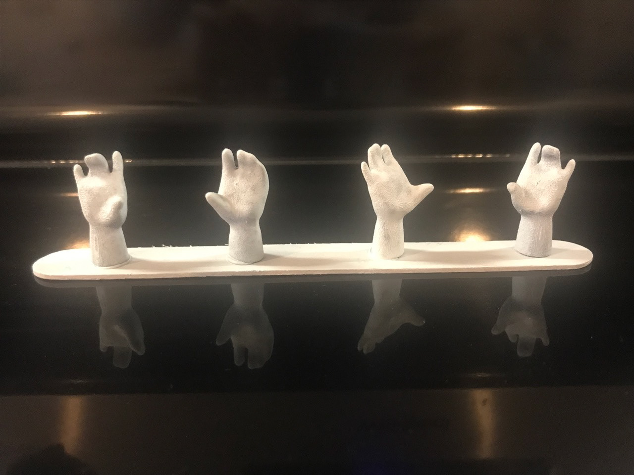 Hands cast in plastic, ready to paint