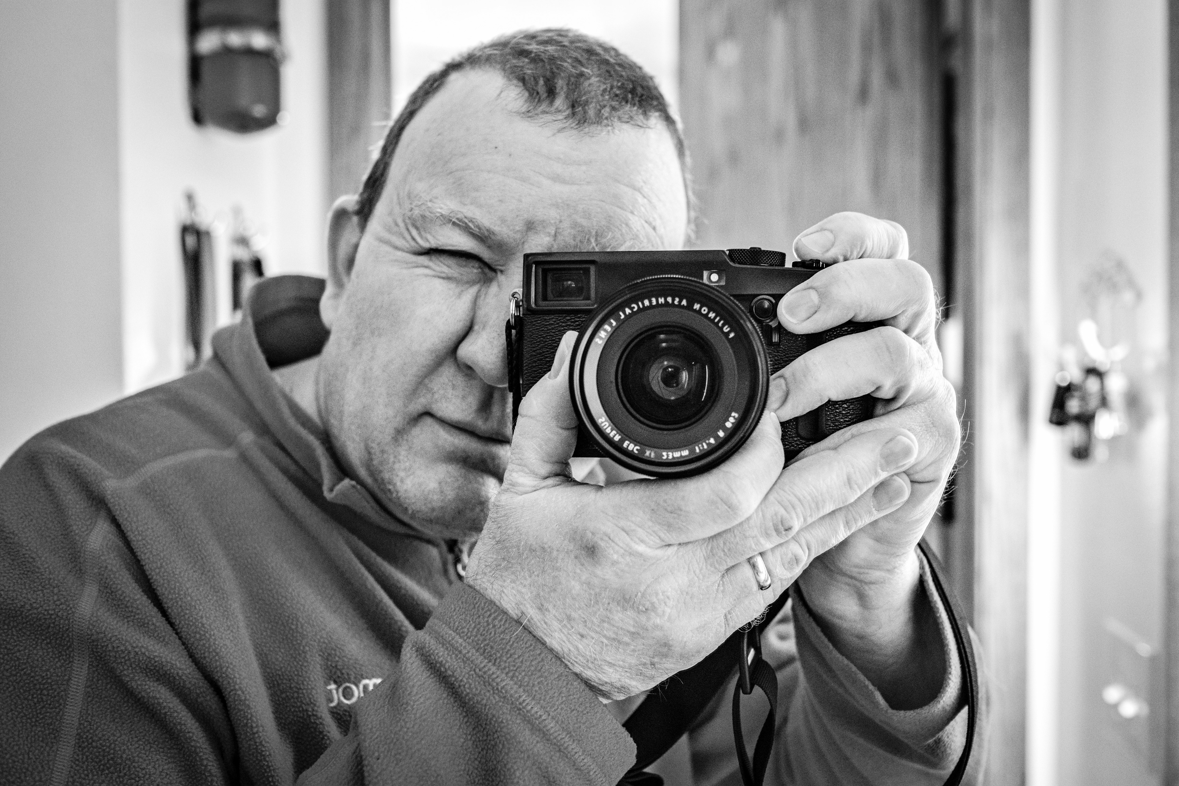 Bill Kapinski looking through his camera in a mirror