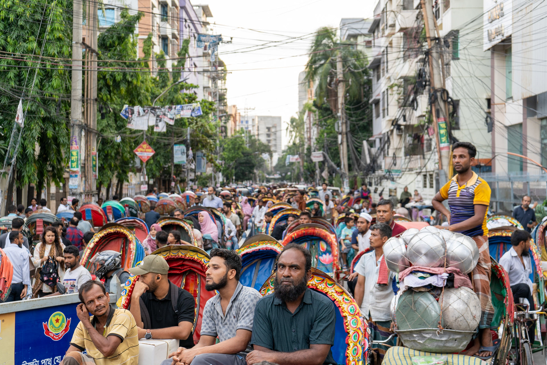 A crowd forms due to protest-related street closures in Dhaka, Bangladesh