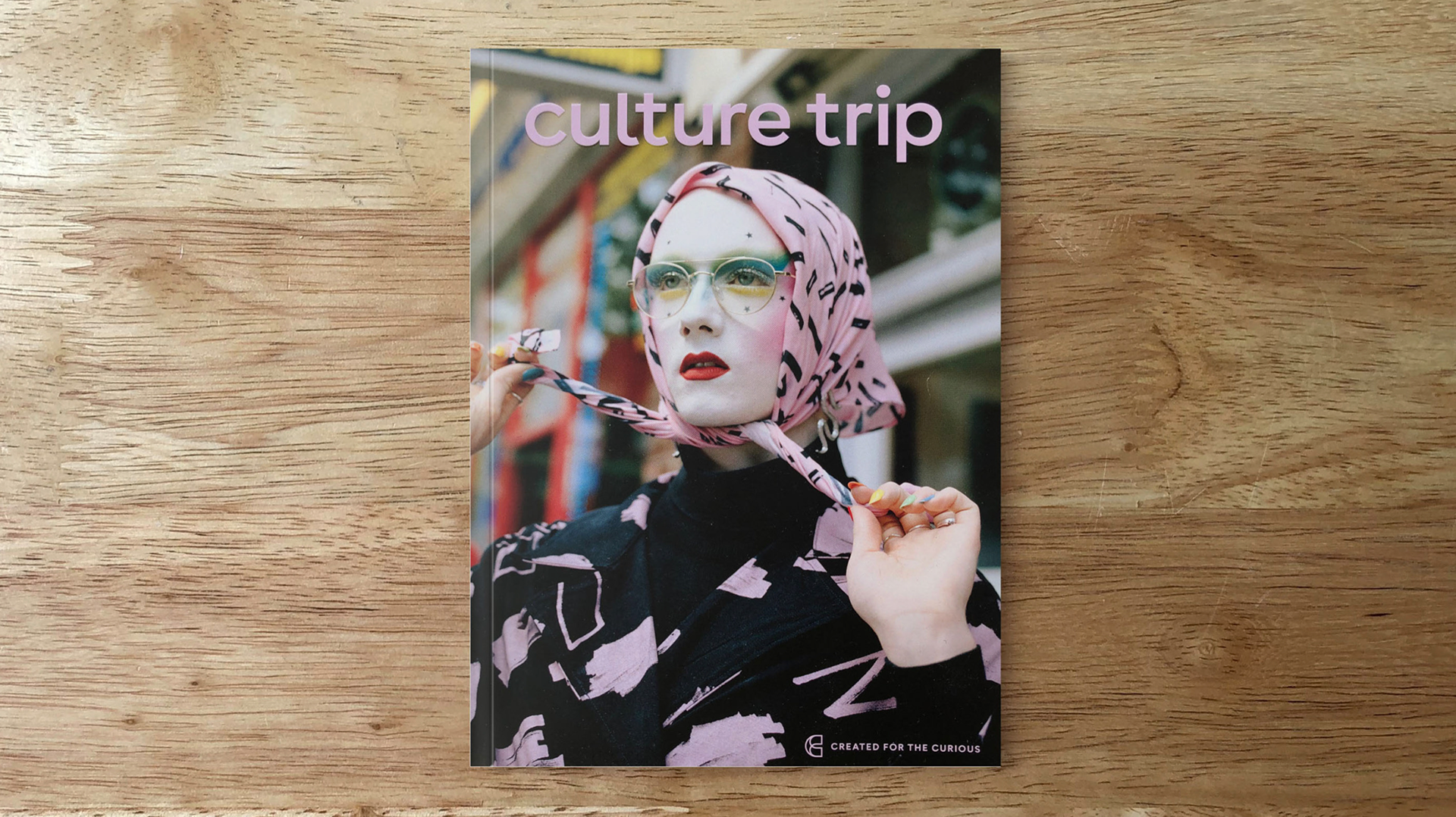 Culture Trip magazine cover featuring a woman in a pink patterned headscarf and round glasses holding a spoon, with the tagline 'Created for the Curious' on a wooden surface.