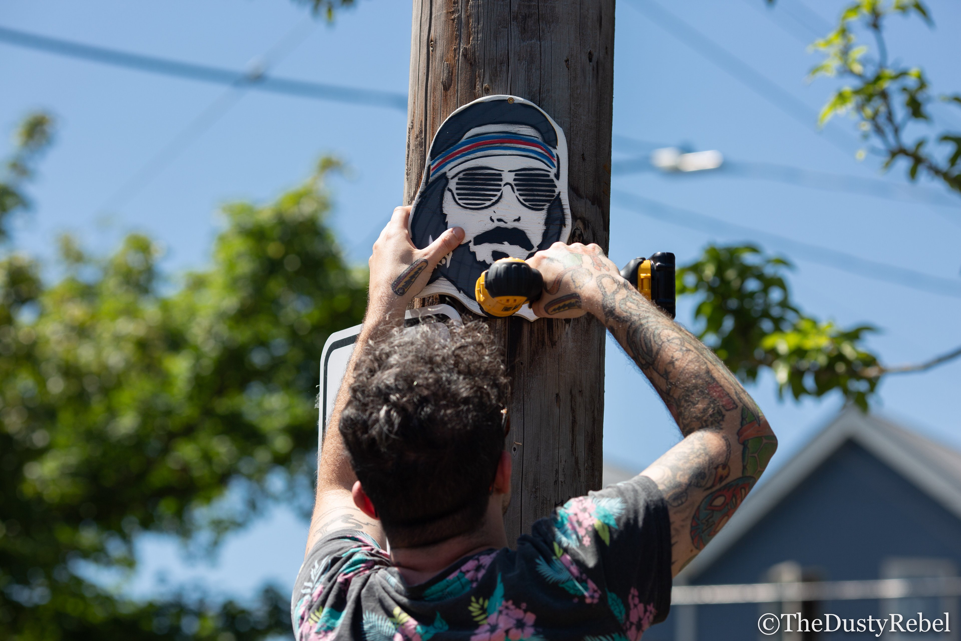Ace Troy installing one of his pieces in Portland (2019)
