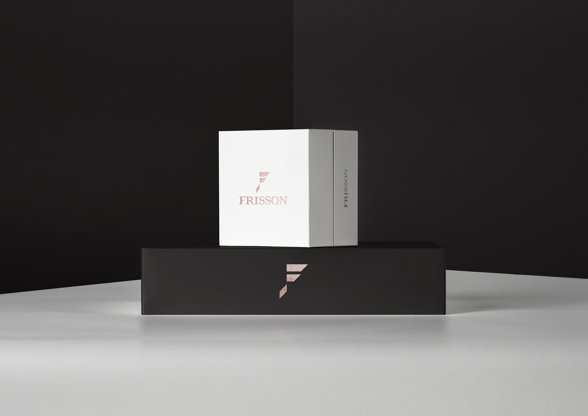 Frisson luxury brand identity featuring the logo and geometric monogram on textured paper by Dima Rykov