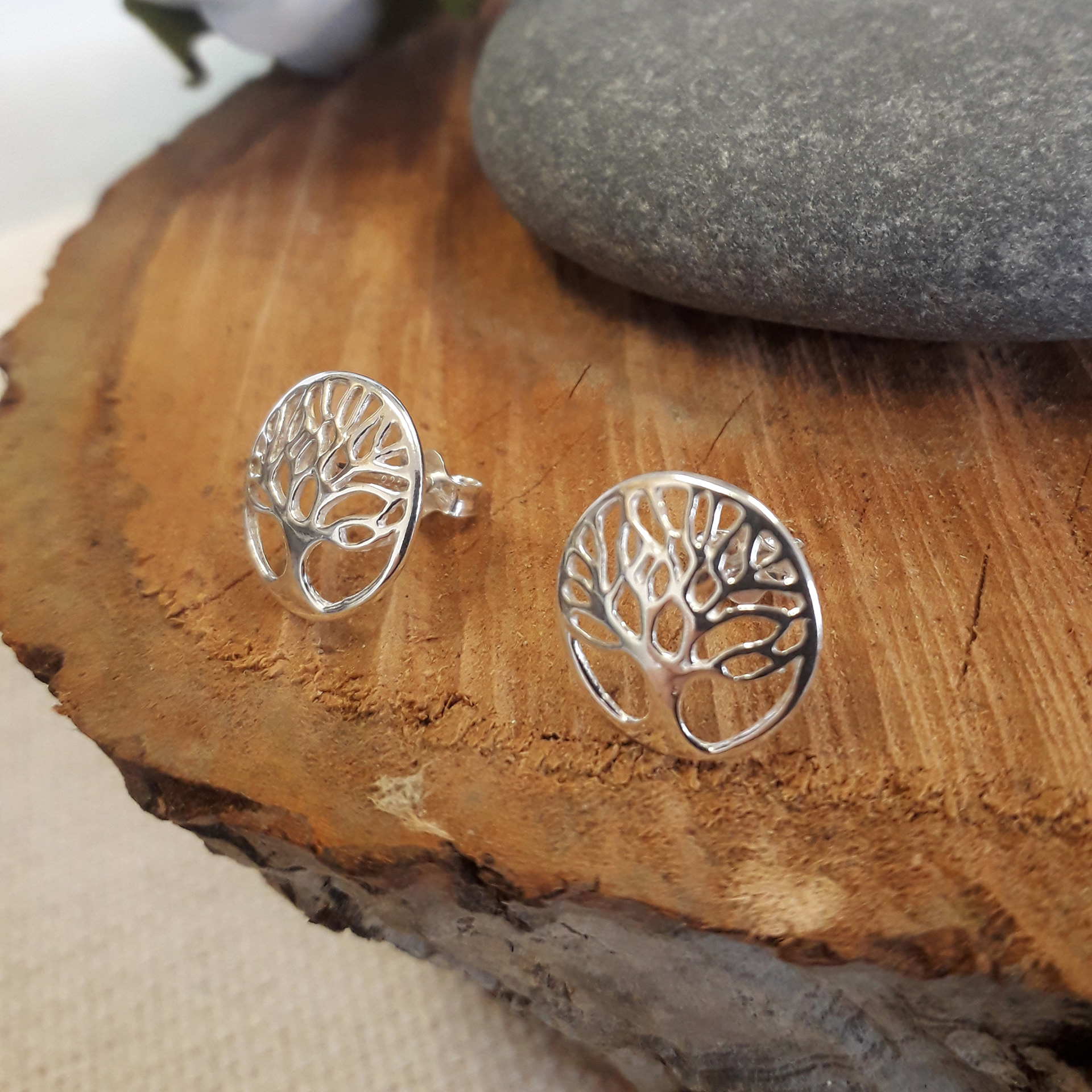 More product photography, this one featuring tree earrings on a tree slice