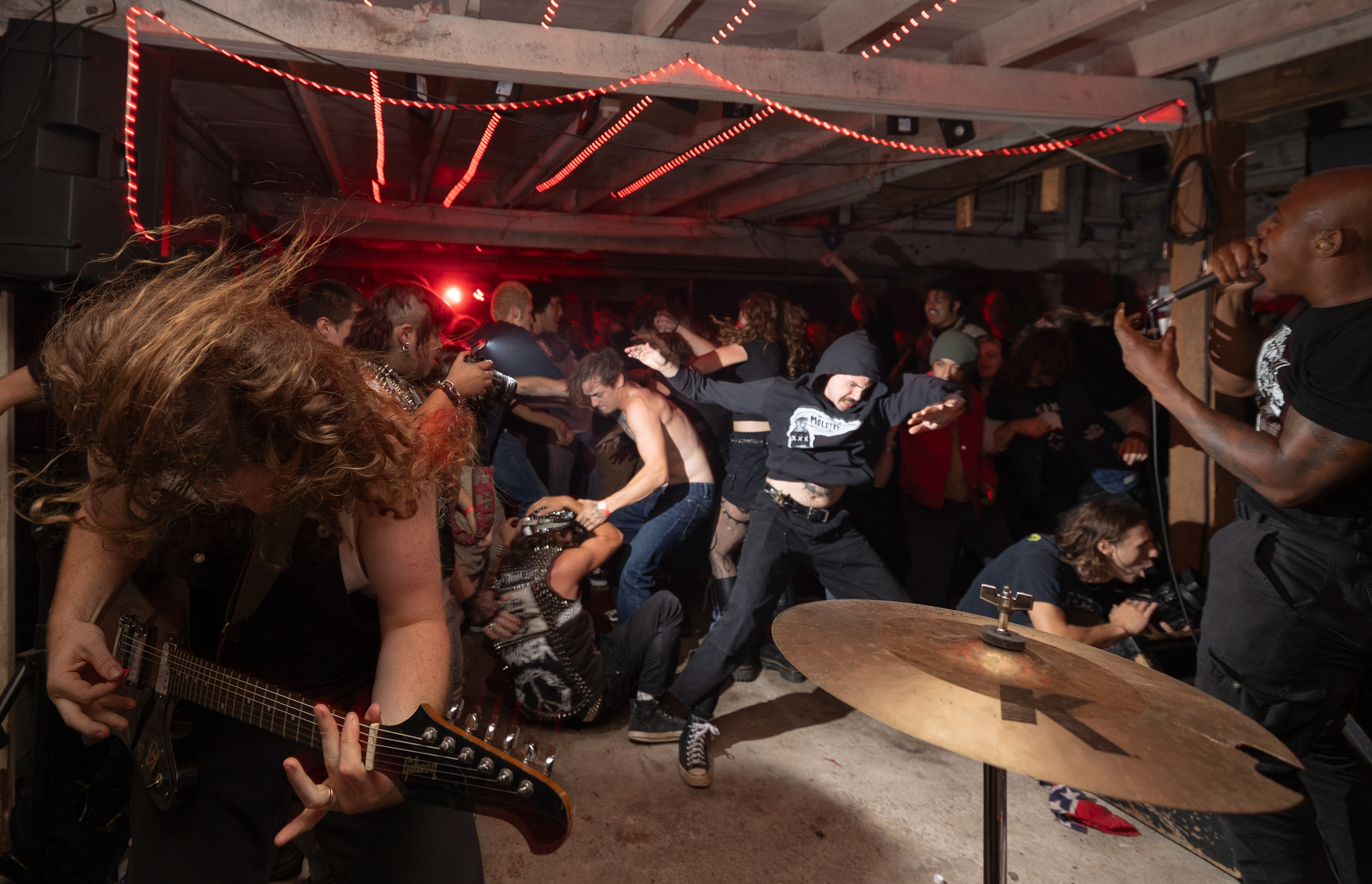 Chaos erupts in the mosh pit as Rat Piss guitarist Brayden Conrad hits a heavy note in a chorus of their final show at Molotov Skateshop on Oct. 14, 2023. The collective urged everyone to join the mosh pit top celebrate the ‘death’ of the band name. The band performed their last show as Rat Piss, only to rebrand themselves as Black Forces Hates You.