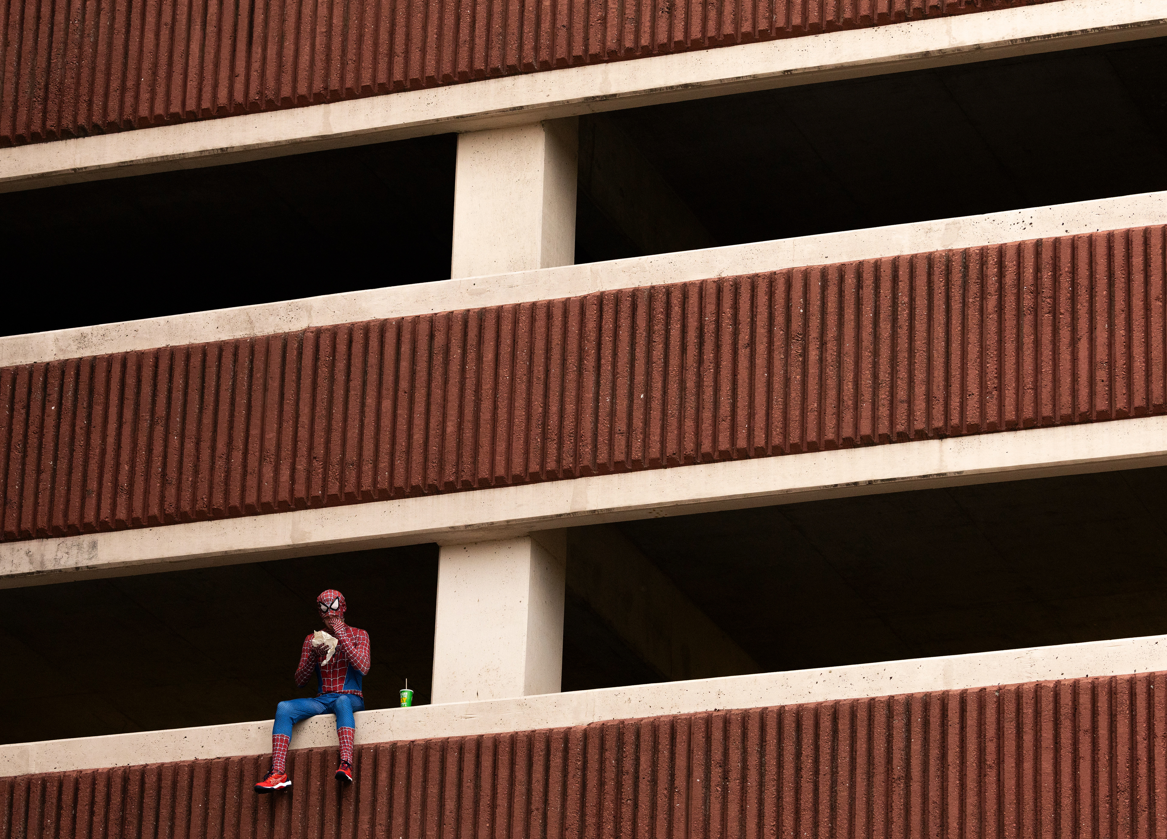 WKU Spidey eats his dinner on the side of PS2, Western Kentucky University’s parking garage as he watches over the campus on Tuesday, Sept. 23, 2025, in Bowling Green, Ky. WKU Spidey was one of the various superheroes to arise after the arrival of the “WKU Pisser” and the “WKU Gooner” accounts on TikTok. “We’re hoping to catch them,” WKU Spidey said. “We’ve got some leads and we’re working with the WKU Police.”