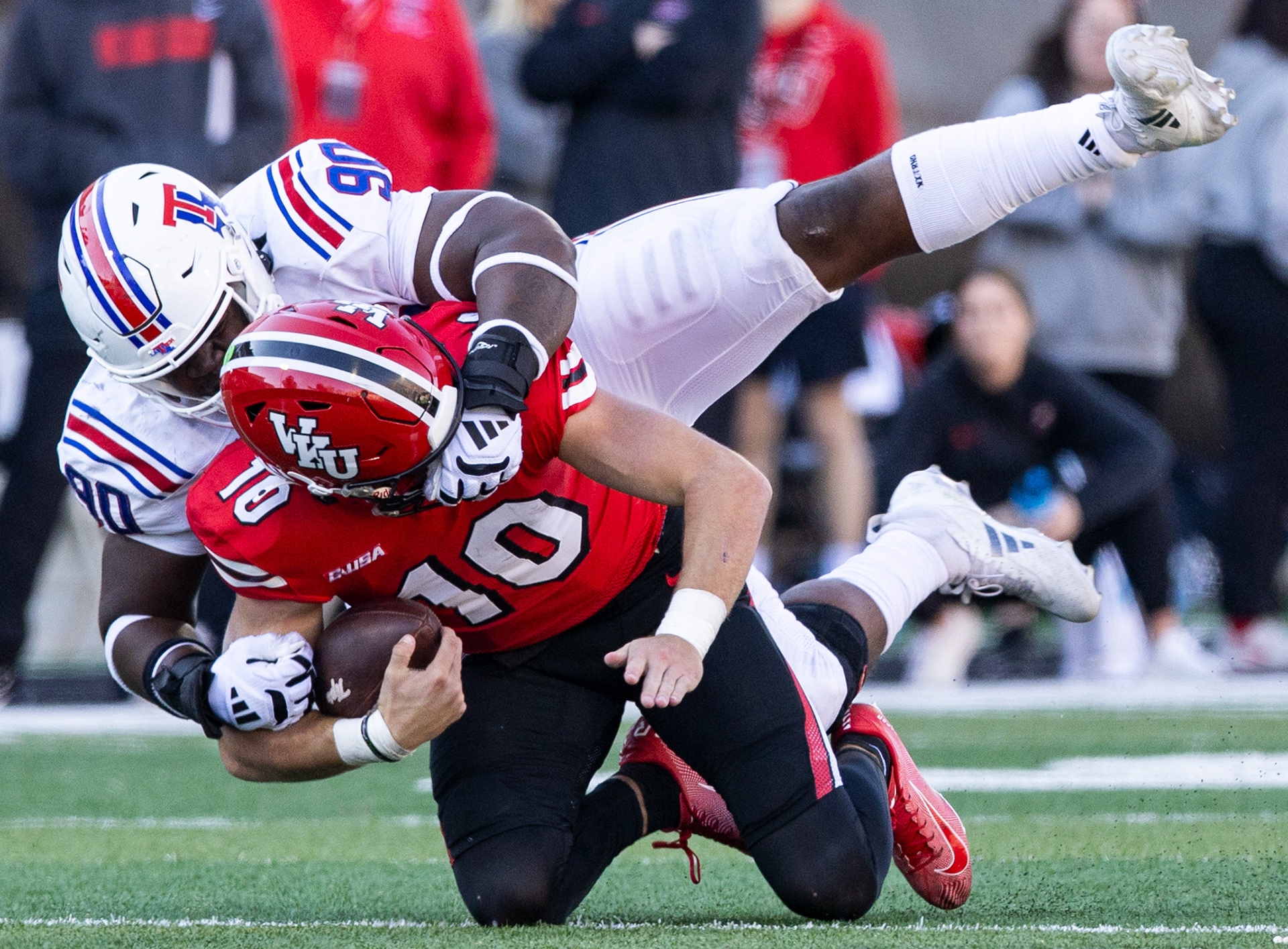Western Kentucky University quarterback Caden Veltkamp (10) is sacked by Louisiana Tech defensive line David Blay during the Homecoming football game in the L.T. Smith Stadium on Nov. 16, 2024. 