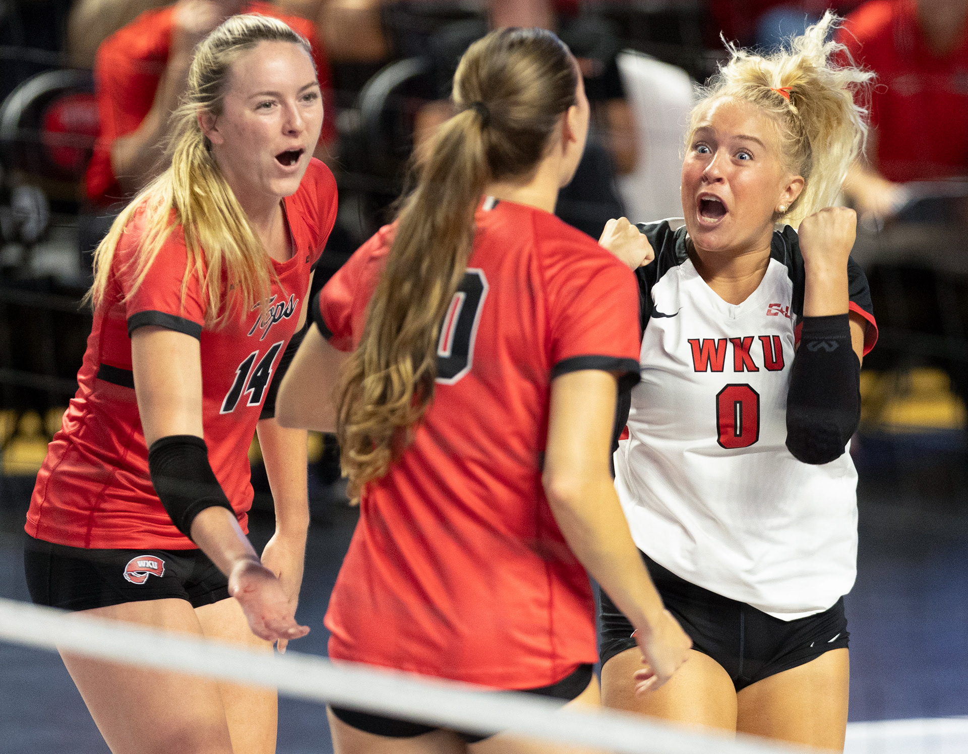 Defensive specialist Callahan Weigandt (0), right, celebrates with teammates during a game against Arkansas State University in Diddle Arena on Sept. 20, 2024.