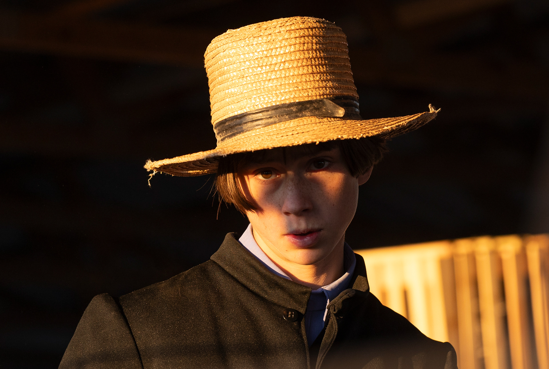 An Amish child looks up after viewing livestock before auction at the 41st annual Amish and Mennonite auction in Scottsville, Ky, on April 6, 2024.