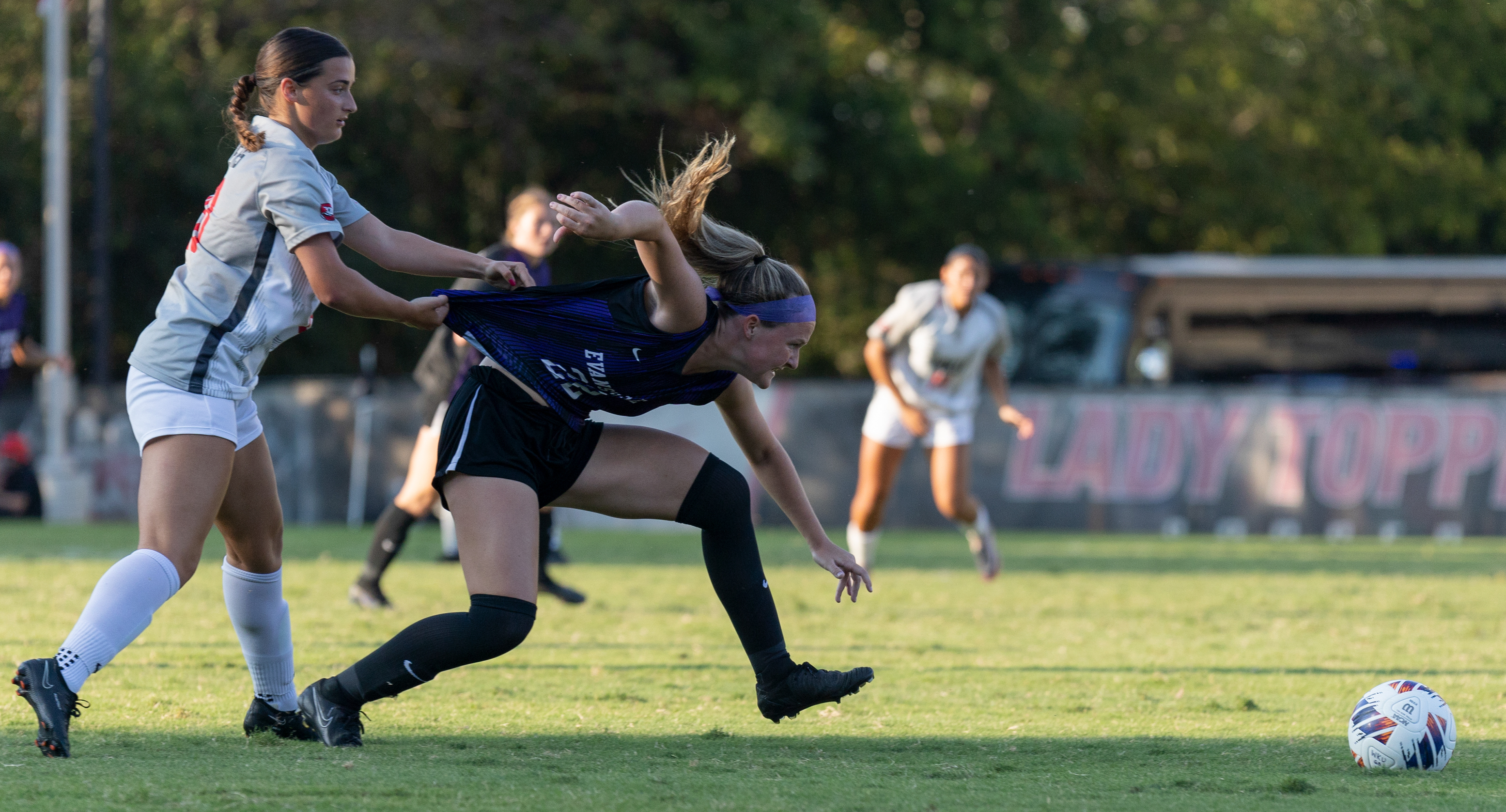 Western Kentucky University midfielder Georgia Liapis, left, pulls on the jersey of Evansville midfielder Ella Hamner during the WKU vs Evansville matchup at the WKU soccer complex on Aug. 25, 2024. WKU won 4-1.
