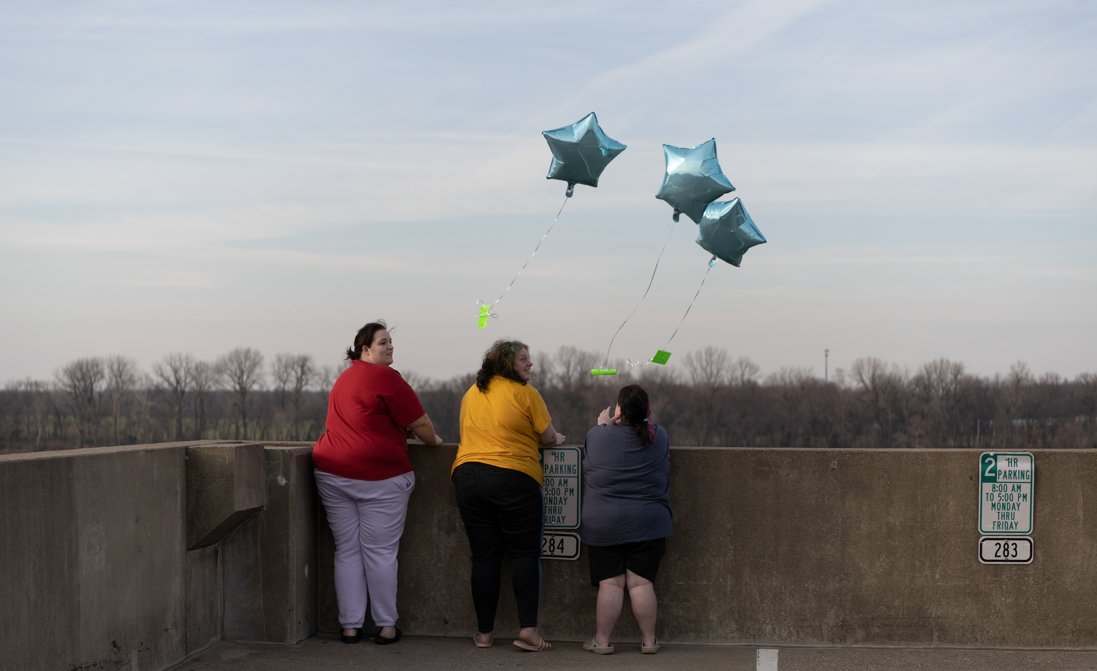 Megan Wood, left, Evie Knapp, center, and Heather Mapes mourn the death of Megan’s nephew, Zerek Burden, on Feb. 25, 2023. Burden died earlier the same day. The three girls released notes attached to the balloons after attending Burden’s funeral. The notes are intended to reach wherever the balloons take them. “The notecards say that we lost my nephew today, and to reach out to see wherever the notes land.” Wood said. 