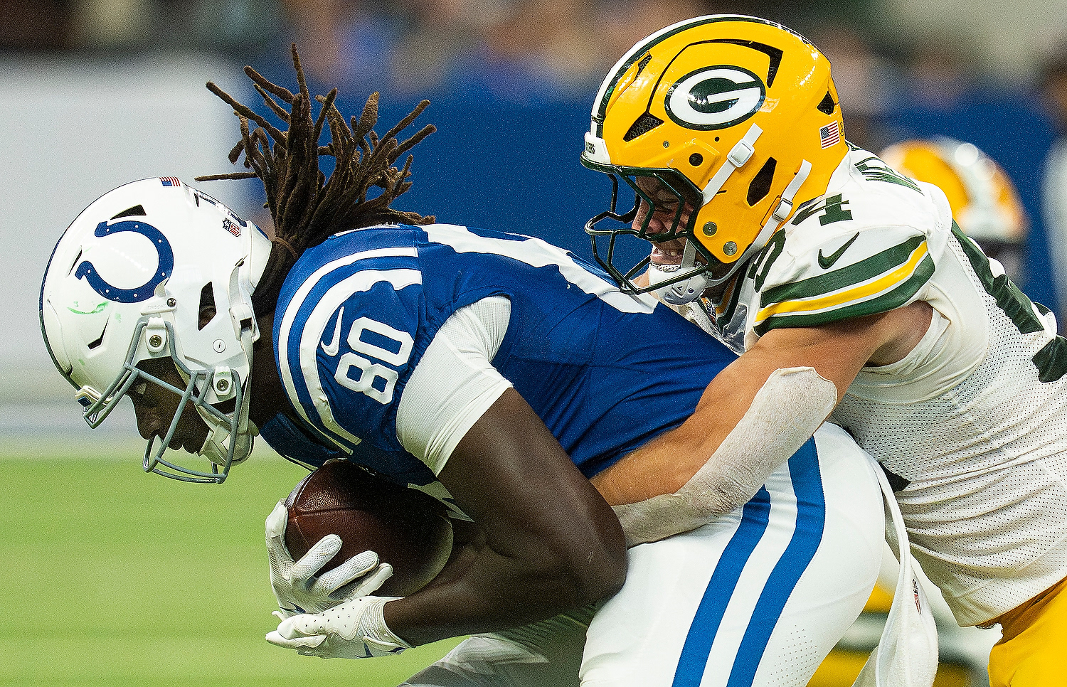 Indianapolis Colts tight end Jelani Woods (80) is tackled by Green Bay Packers linebacker Kristian Welch (54) on Saturday, Aug. 16, 2025, during a game against the Green Bay Packers at Lucas Oil Stadium in Indianapolis.