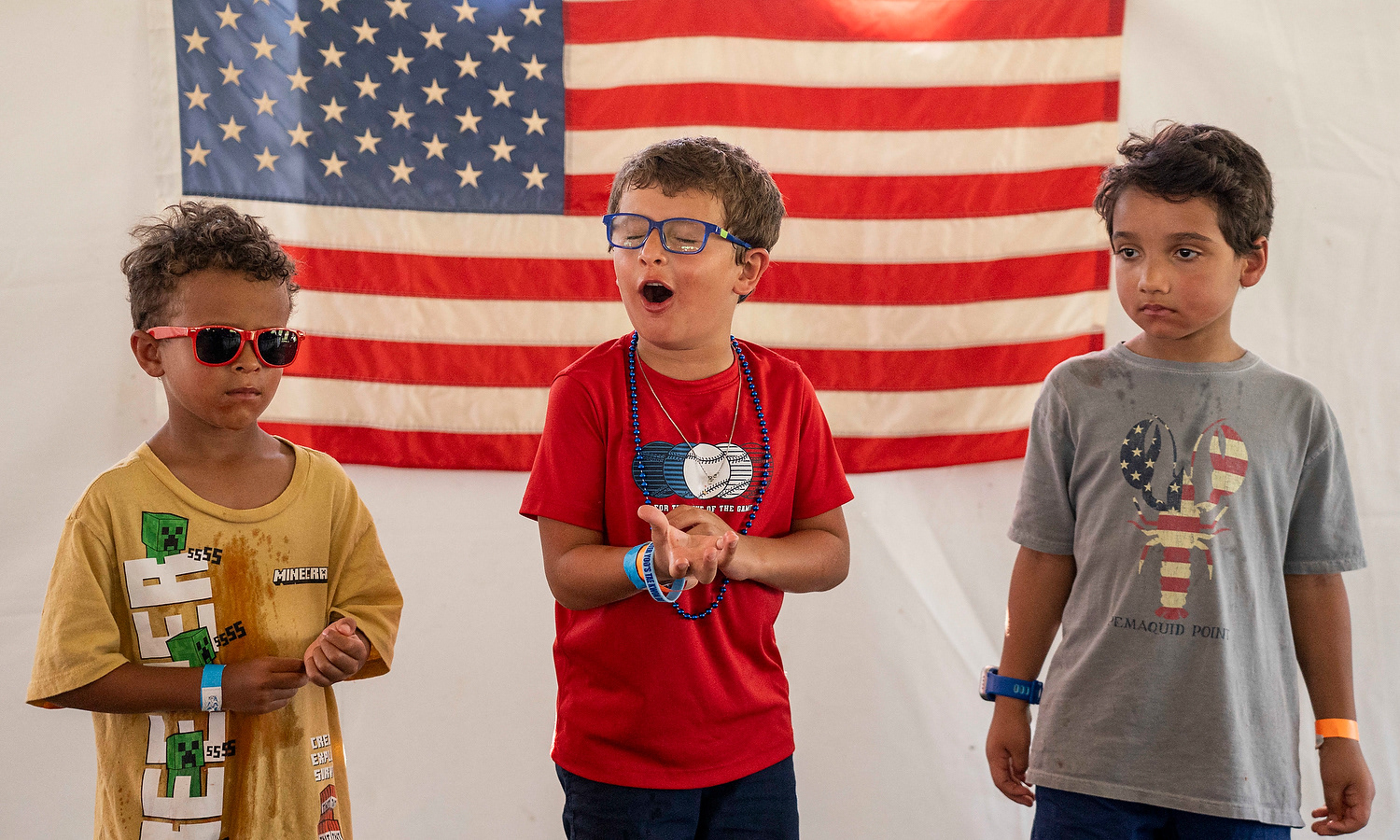 Griffin Warling, 5, yells triumphantly among the three victors of the 3-6 age range of the ‘Westfield Rocks the 4th’ youth watermelon eating contest on Friday, July 4, 2025, at Grand Park in Westfield, Ind. 
