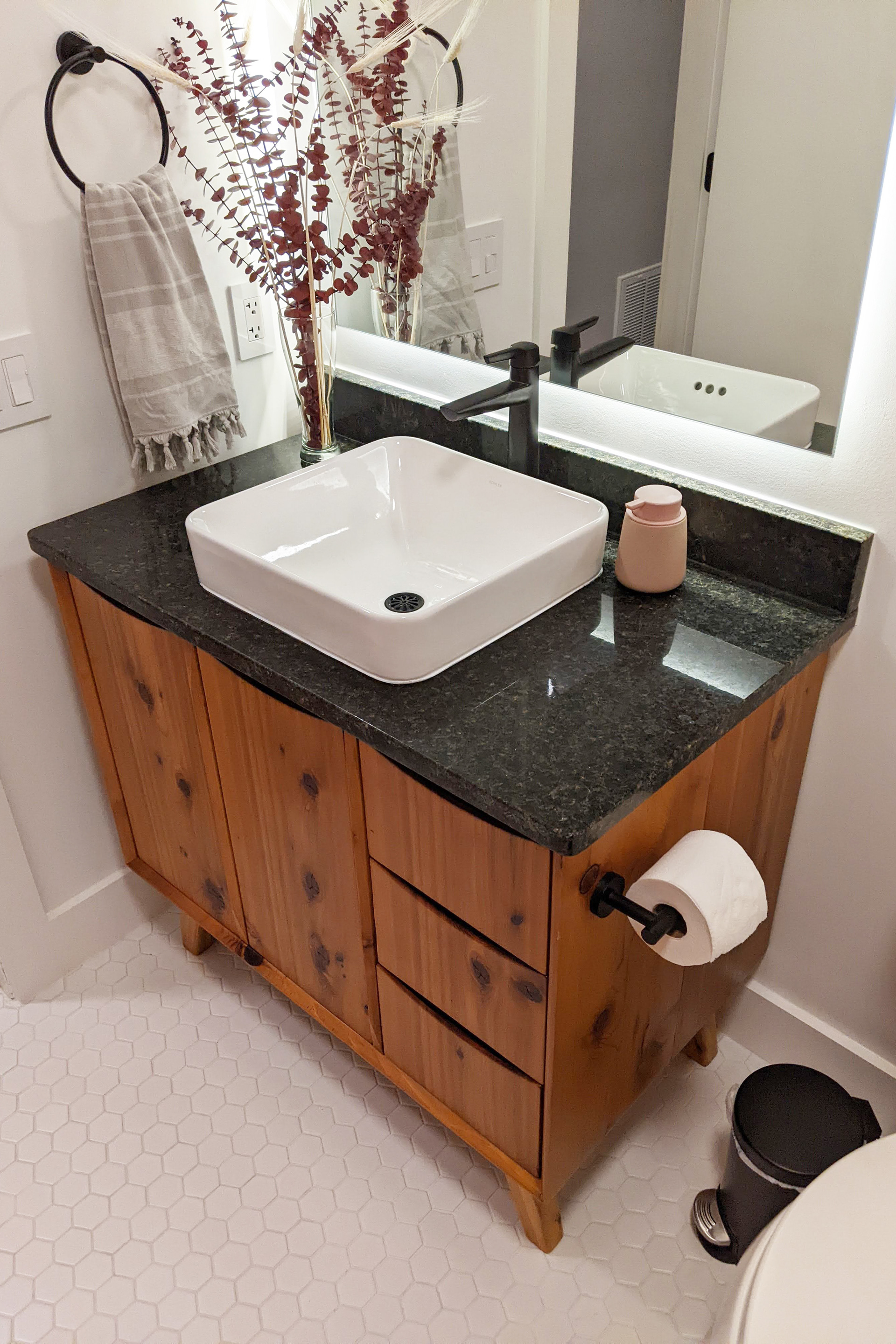 Bathroom after. New everything: tile, paint, tub, toilet, vanity.