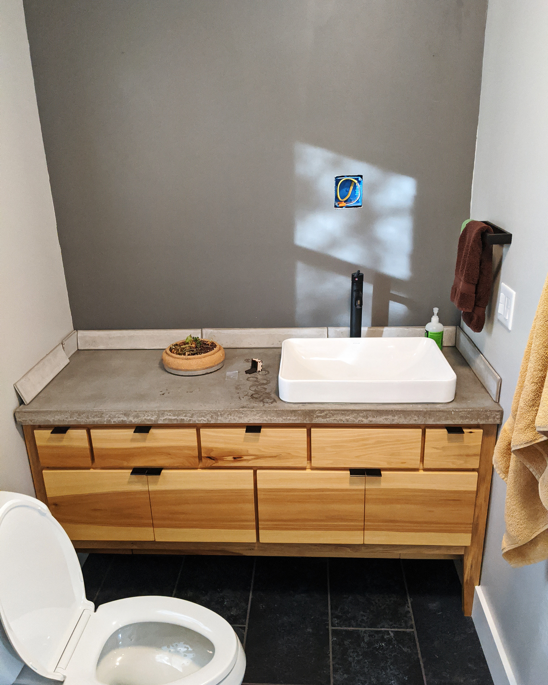 Installing backsplash and preparing for mirror.