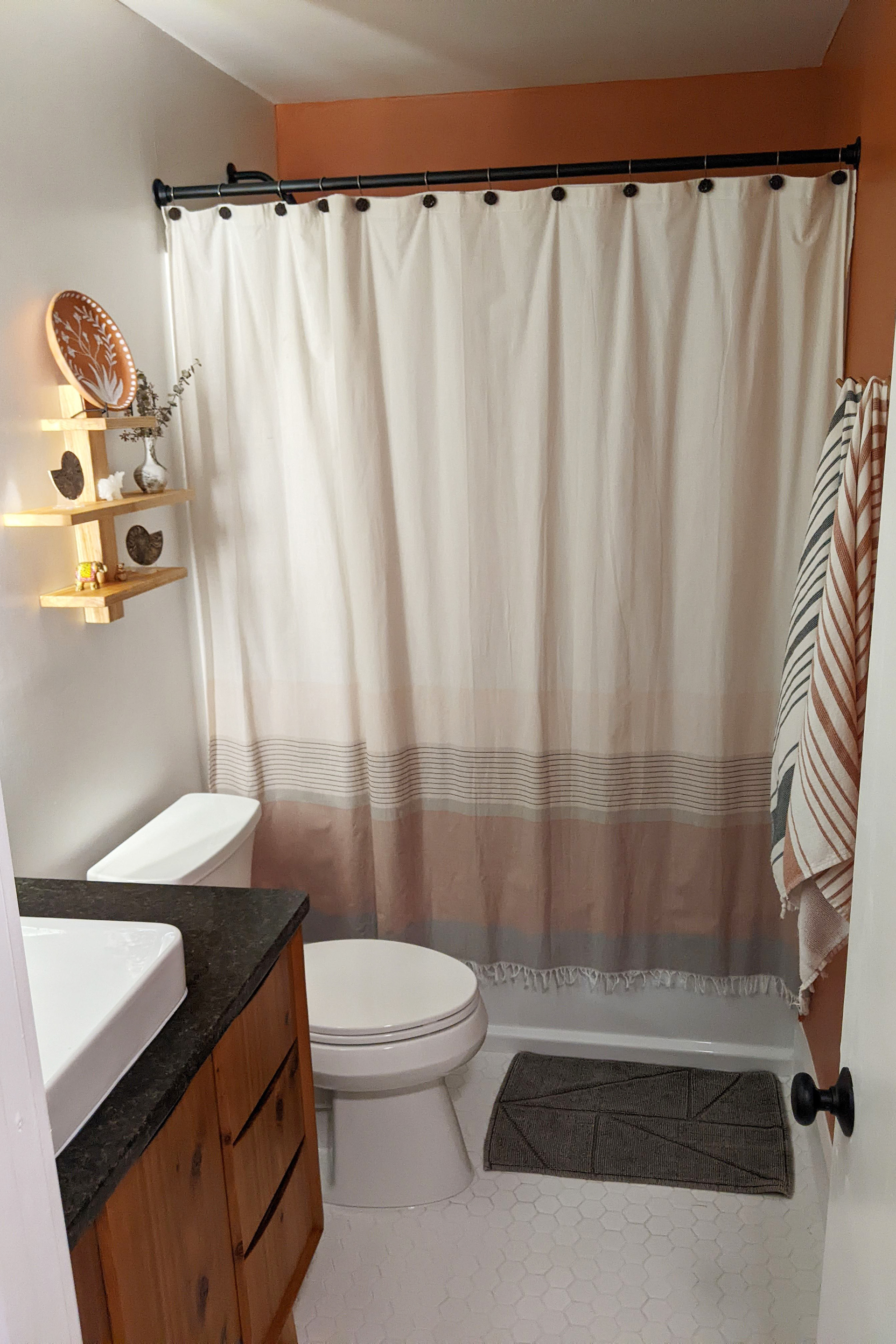 Bathroom after. New everything: tile, paint, tub, toilet, vanity.