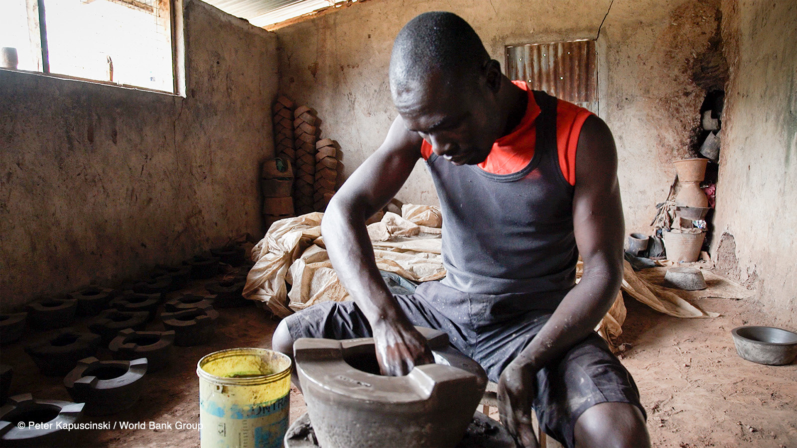 A potter from the Keyo Pottery Women’s group molds a cook stove in Kisumu, Kenya. The group is the premiere stove production facility in the region, producing 1,500 jiko kisasa (firewood stove) stoves, 5,000 ceramic jikos (charcoal stove), and 500 rocket stoves (firewood stove) inserts on a monthly basis. Photo: Peter Kapuscinski / World Bank