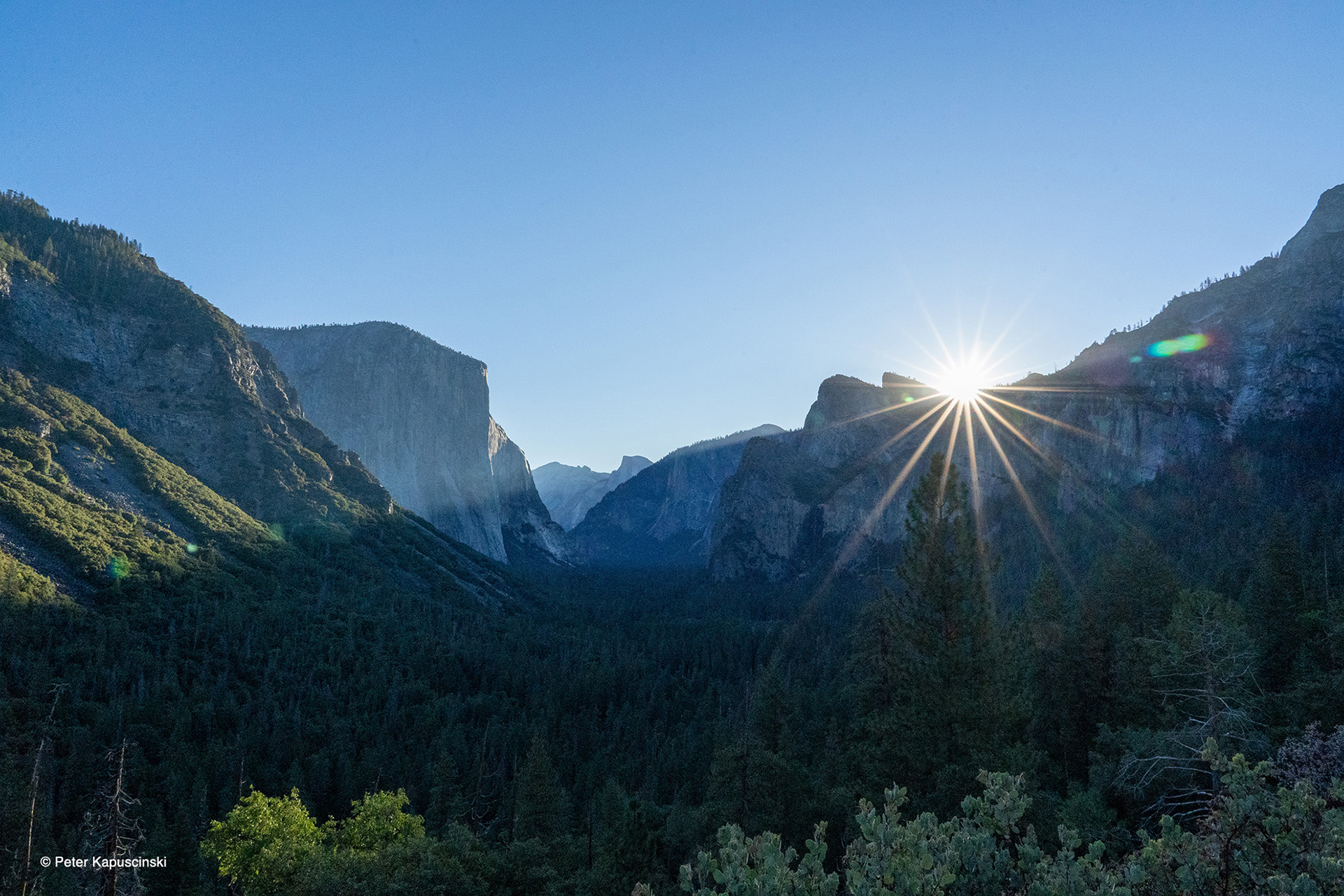 Sunrise in Yosemite Valley from Tunnel View overlook. Designated a World Heritage Site in 1984, millions of people visit Yosemite National Park each year. Photo: Peter Kapuscinski