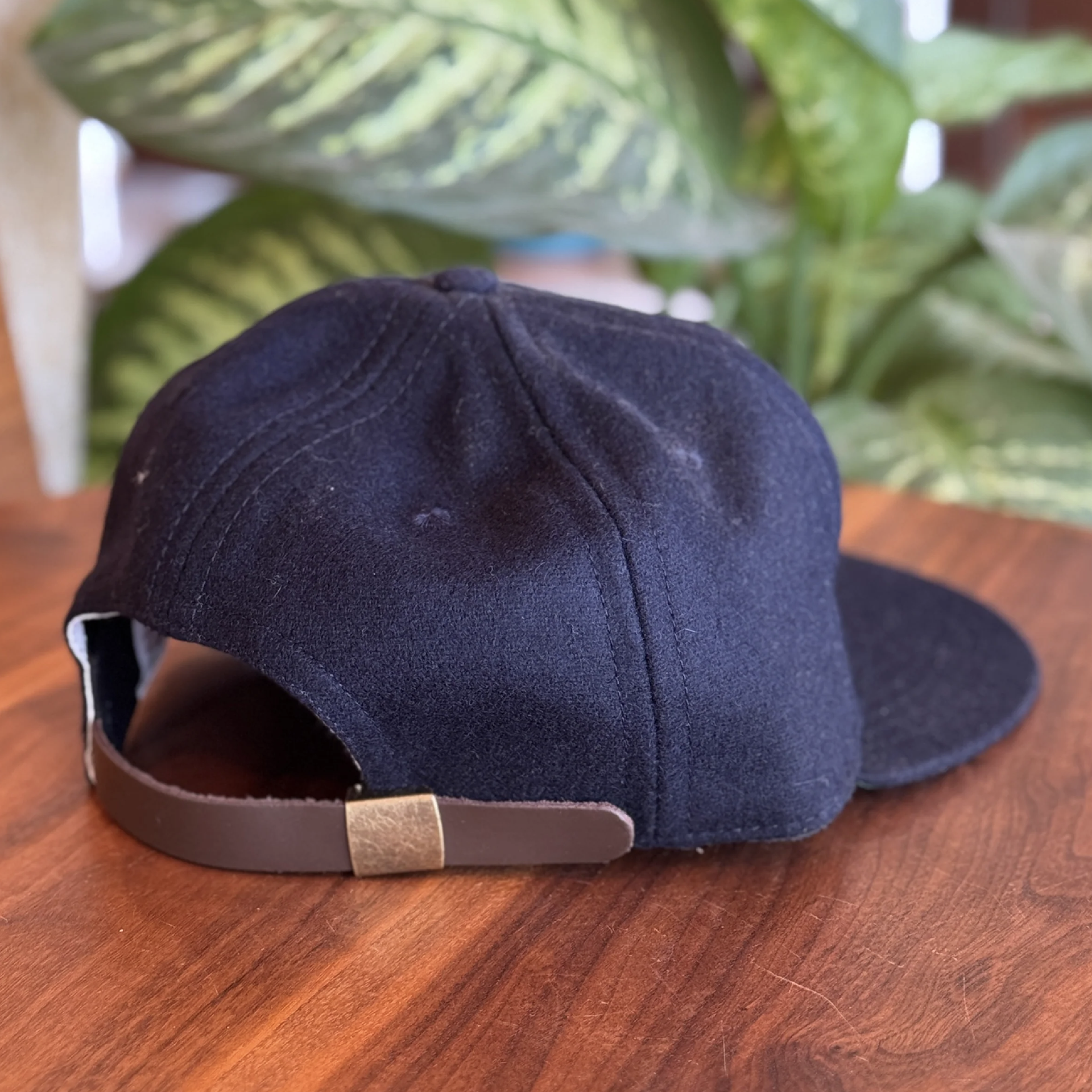 Navy wool, brown leather adjuster