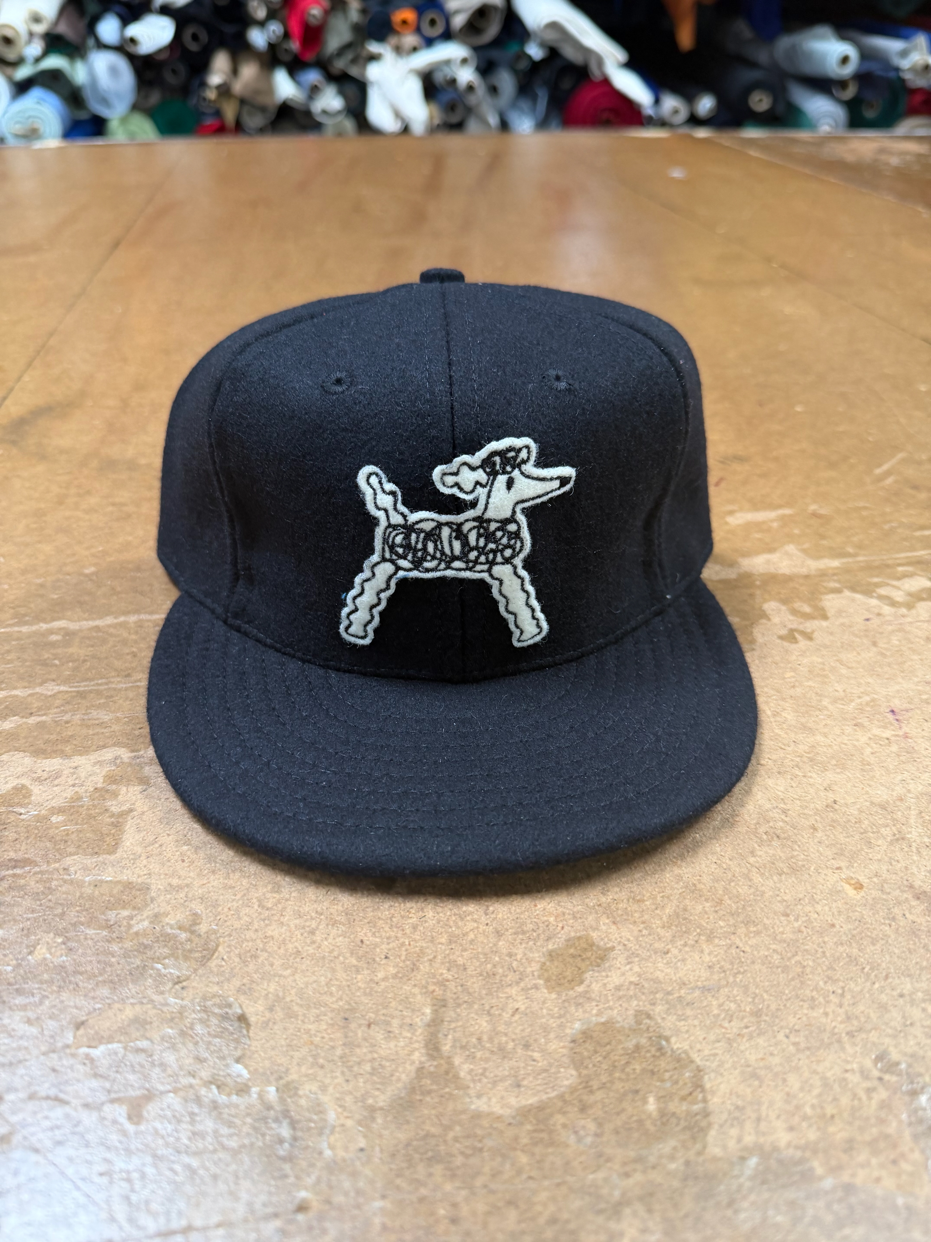 Embroidered felt on black wool