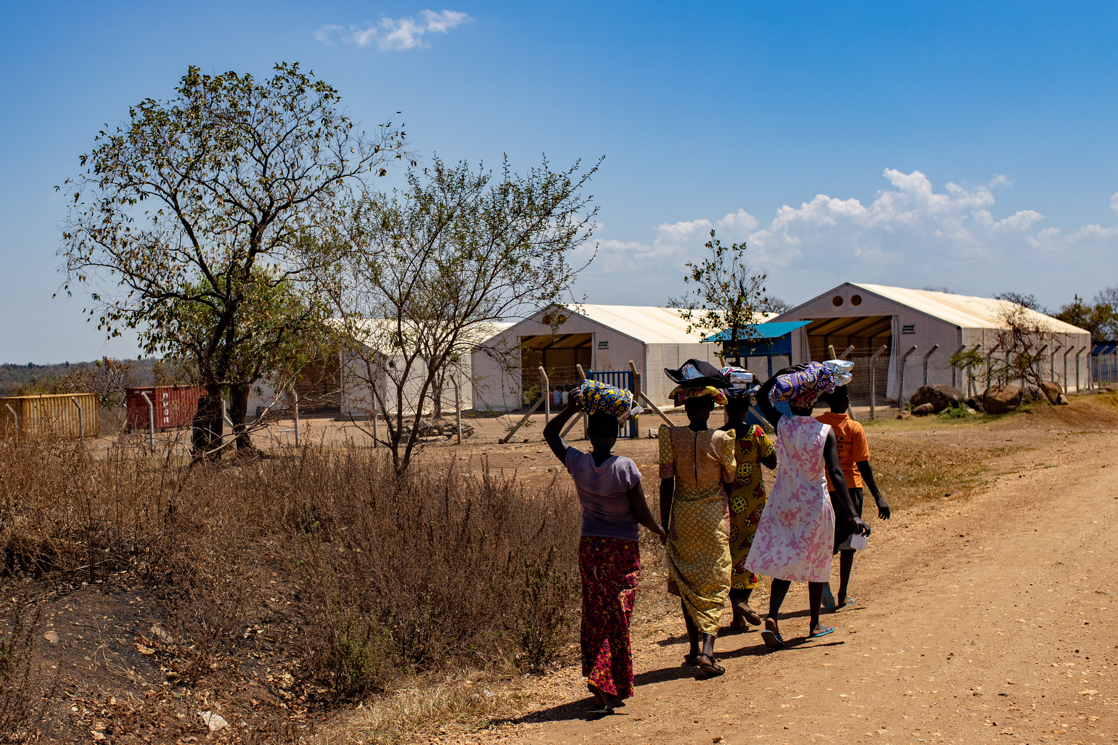 Women walking to the World Food Organization Program in Imvepi Refugee Settlement.