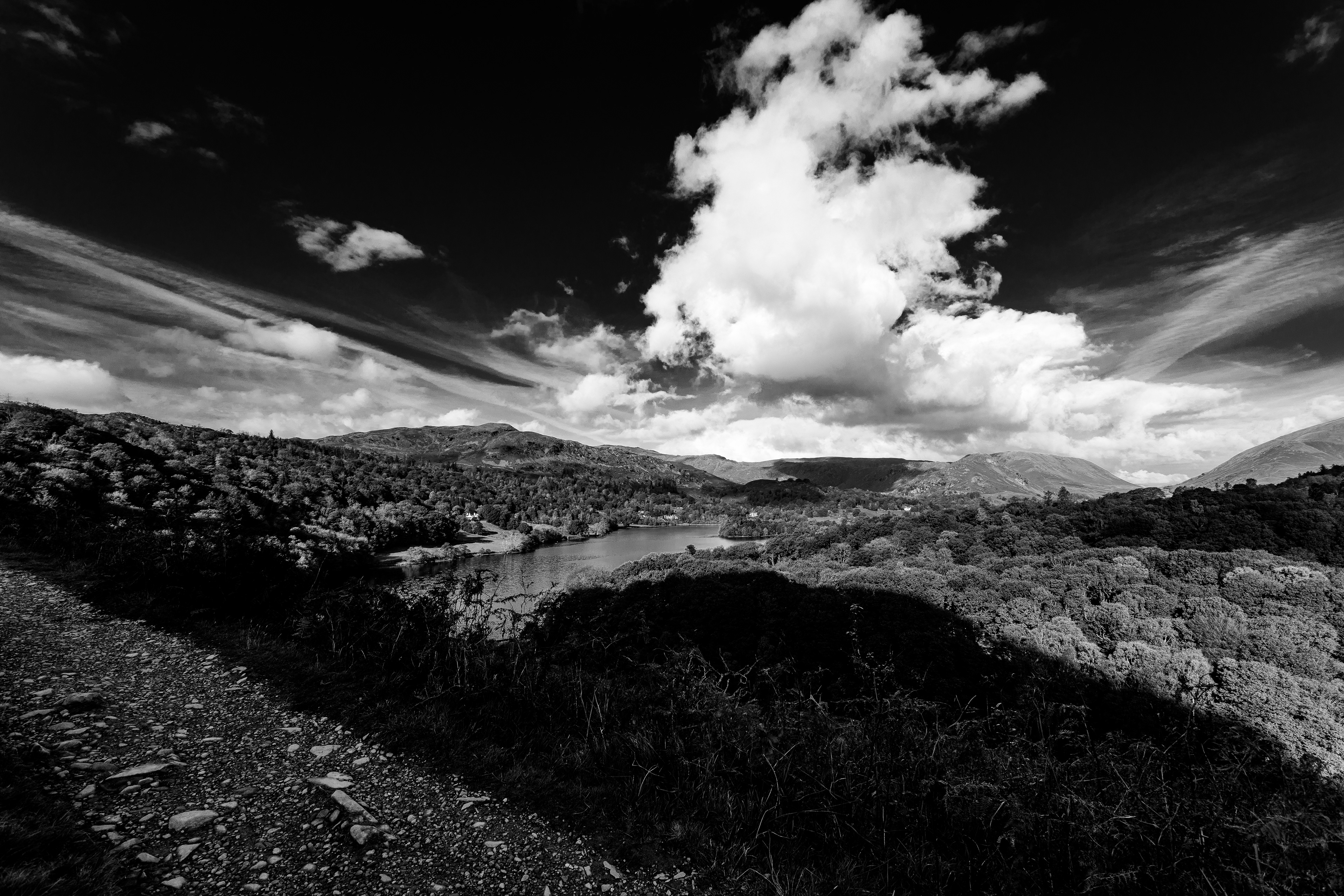 Black and white view over Grasmere with dramatic clouds