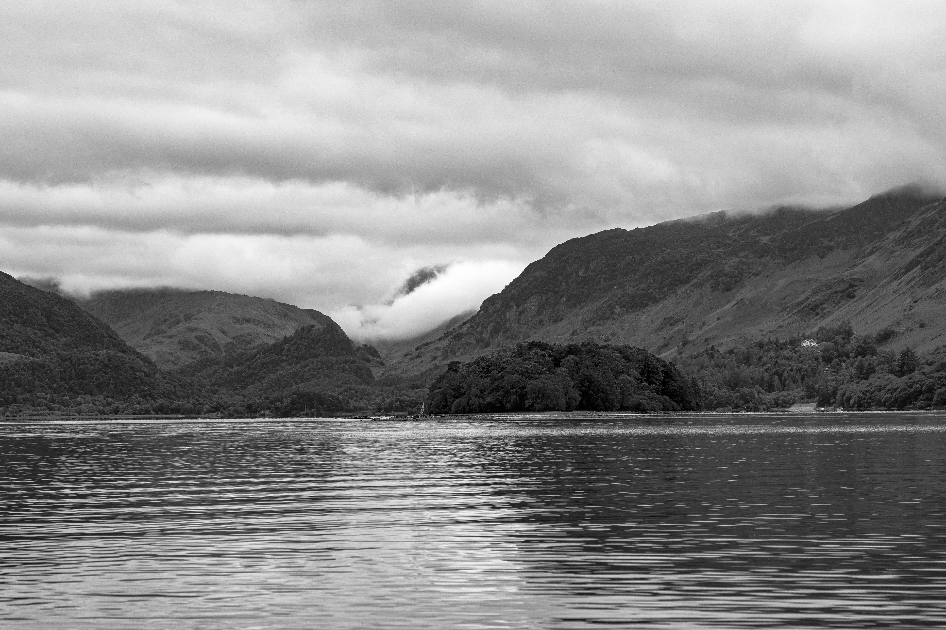Black and white view over Derwent Water with dramatic clouds
