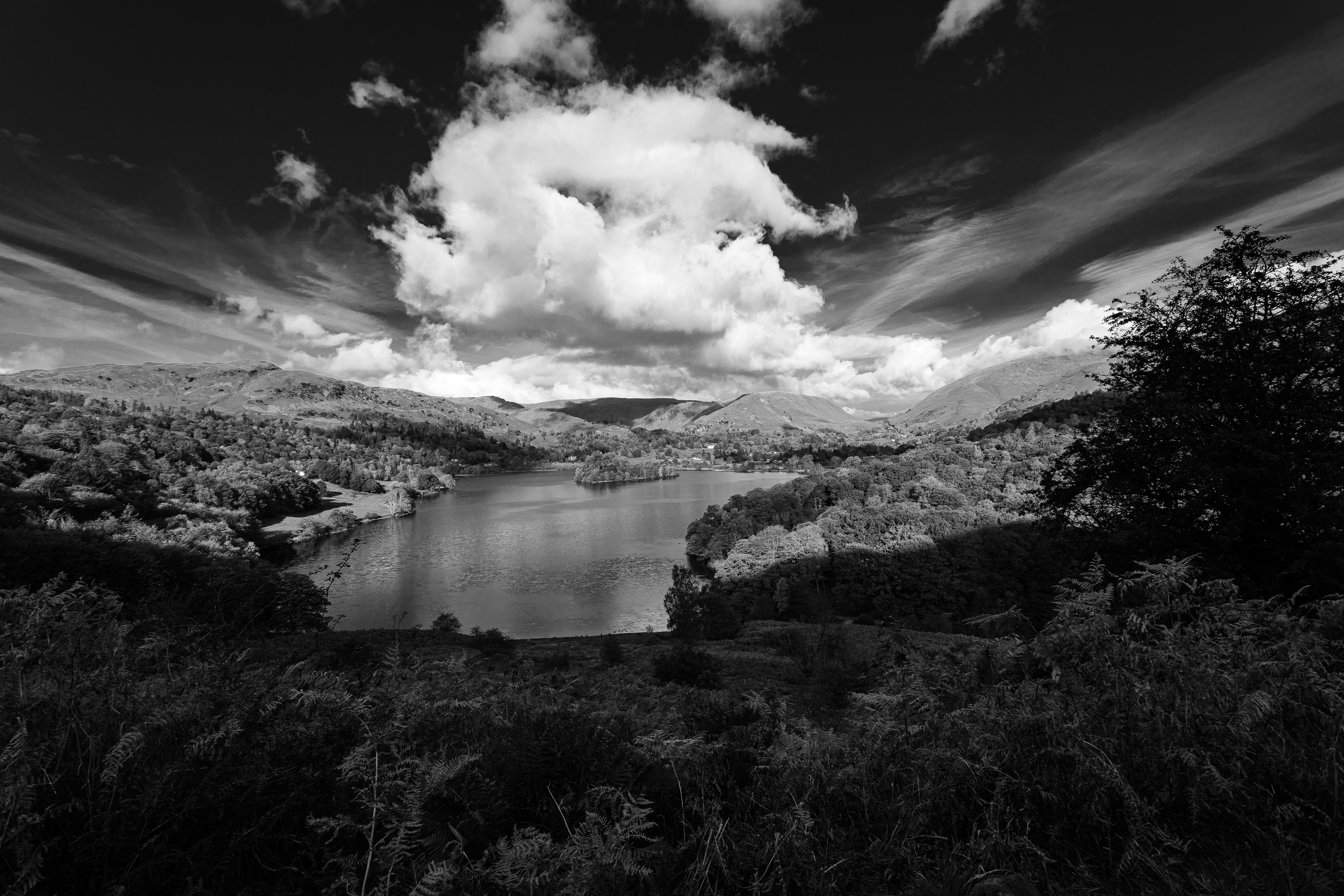 Black and white view over Grasmere with dramatic clouds