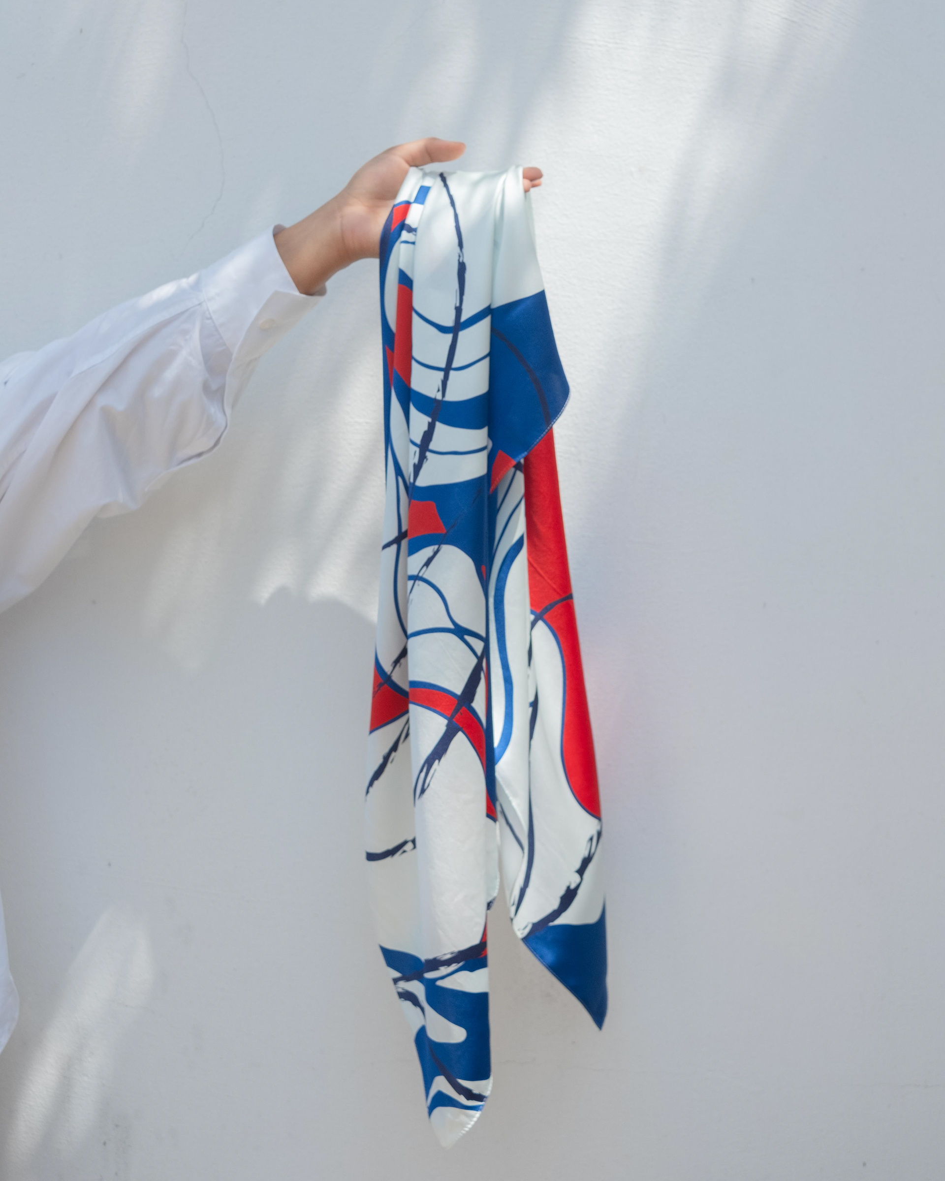 woman hand hanging a printed silk scarf