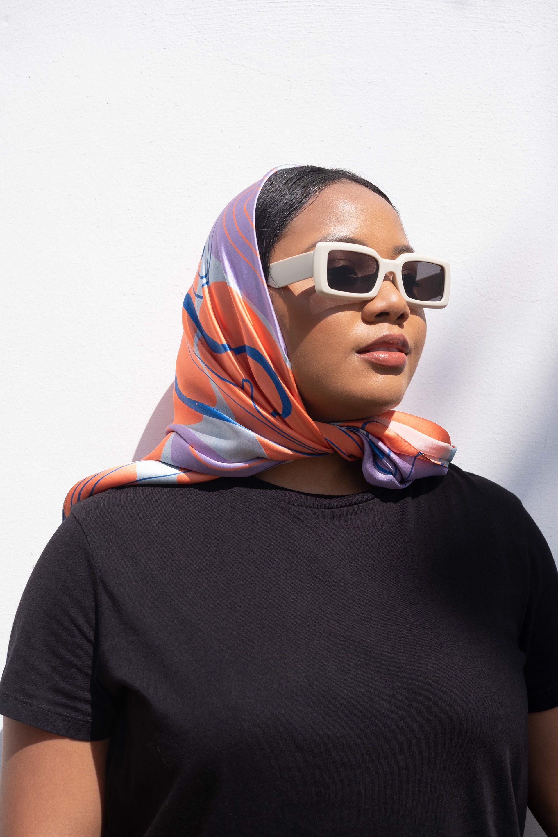 woman wearing the printed silk scarf to cover her head