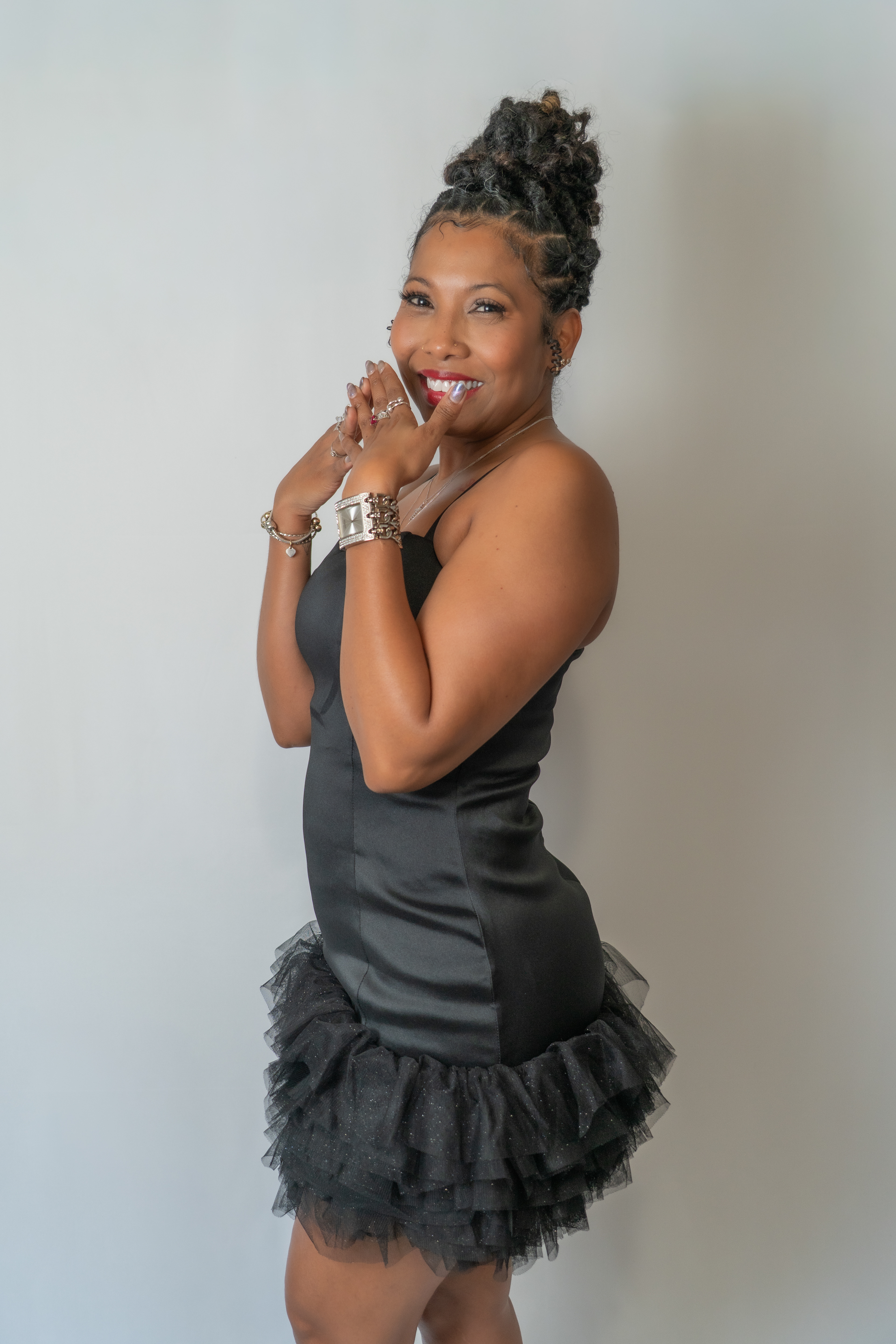 Woman posing for birthday shoot in studio.