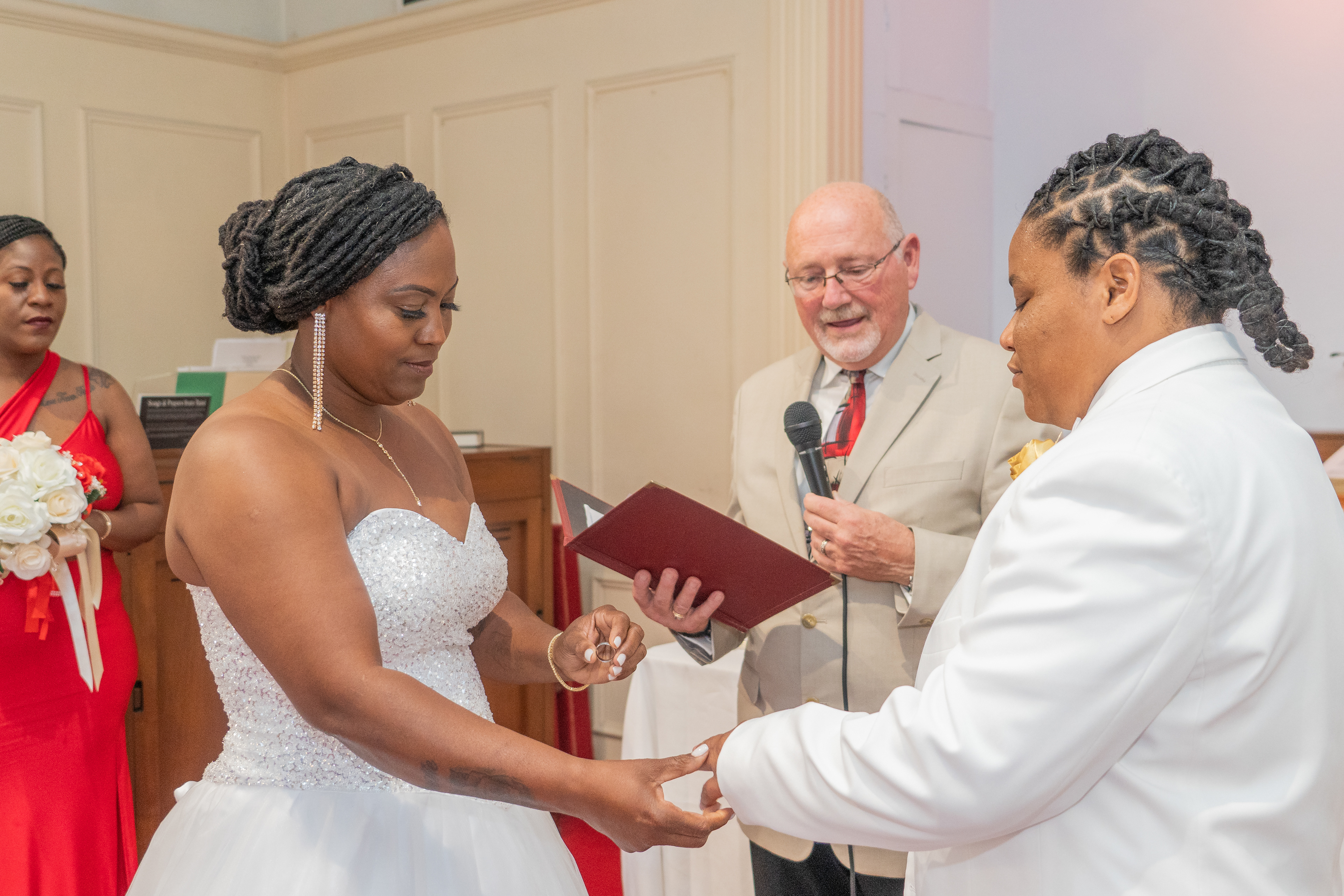 Bride placing ring on Groom's finger at Ceremony in Waukegan, IL