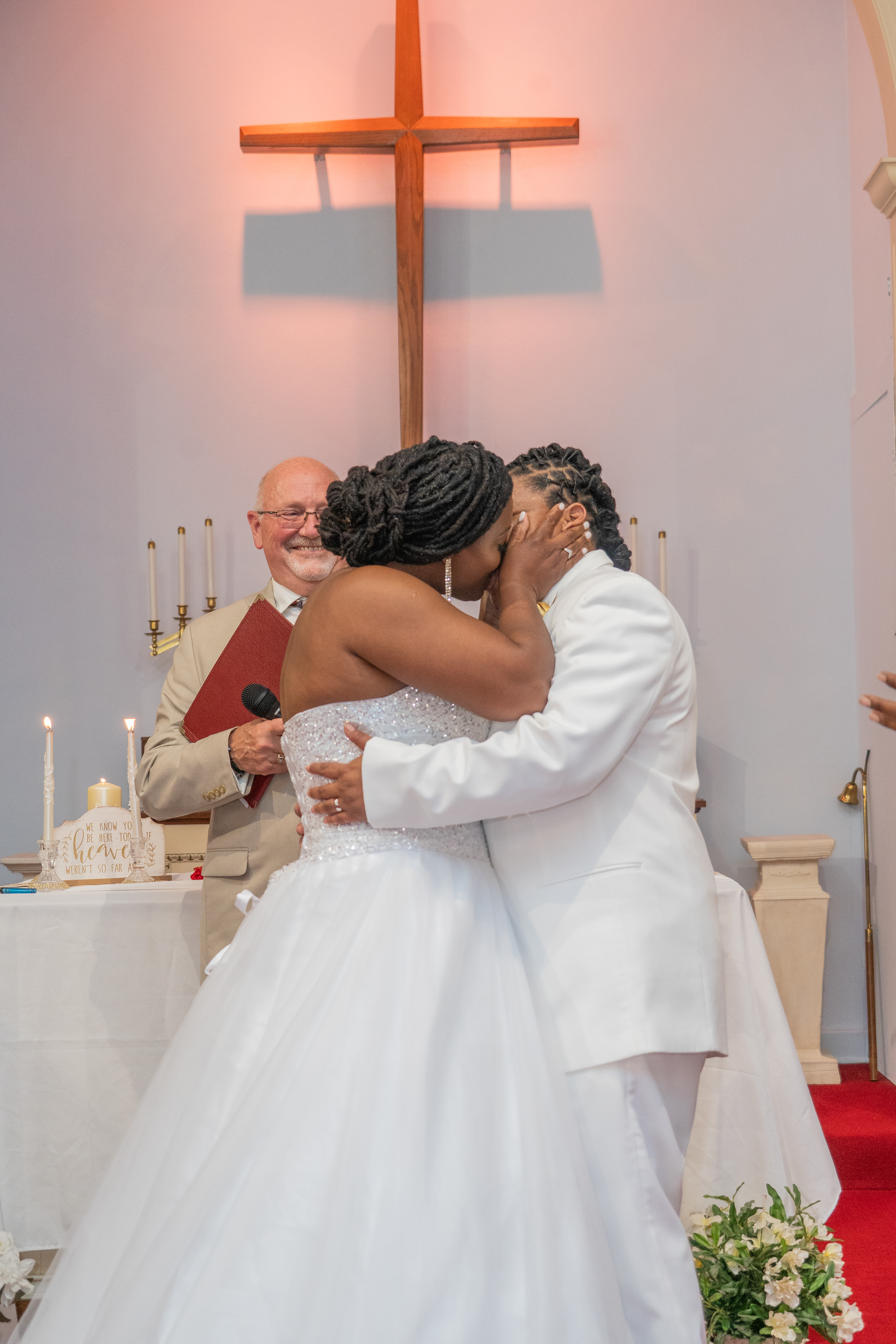 Bride and Groom kisses at altar. Church Ceremony in Waukegan, IL