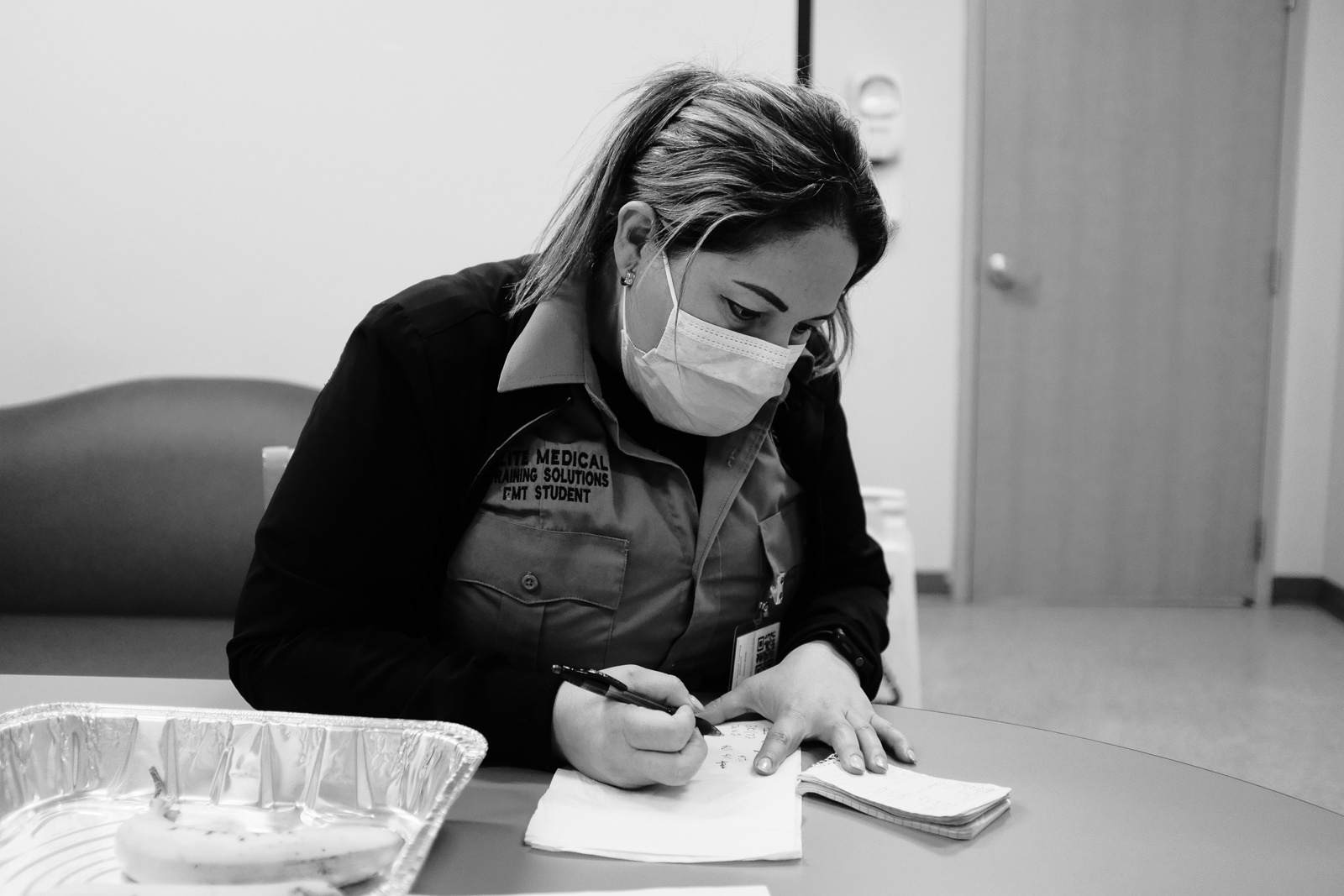 She helps me save a patient from death. Here, she looks through my notes of the call.