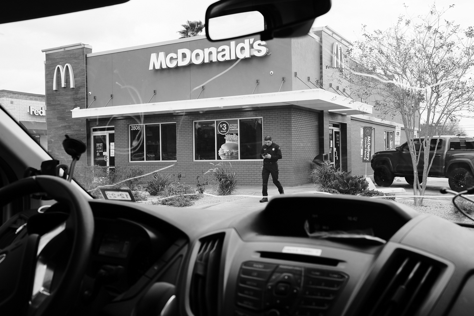 He makes an attempt to get food but soon walking in, he walks out due to a call. He walks back to the unit looking up the address.