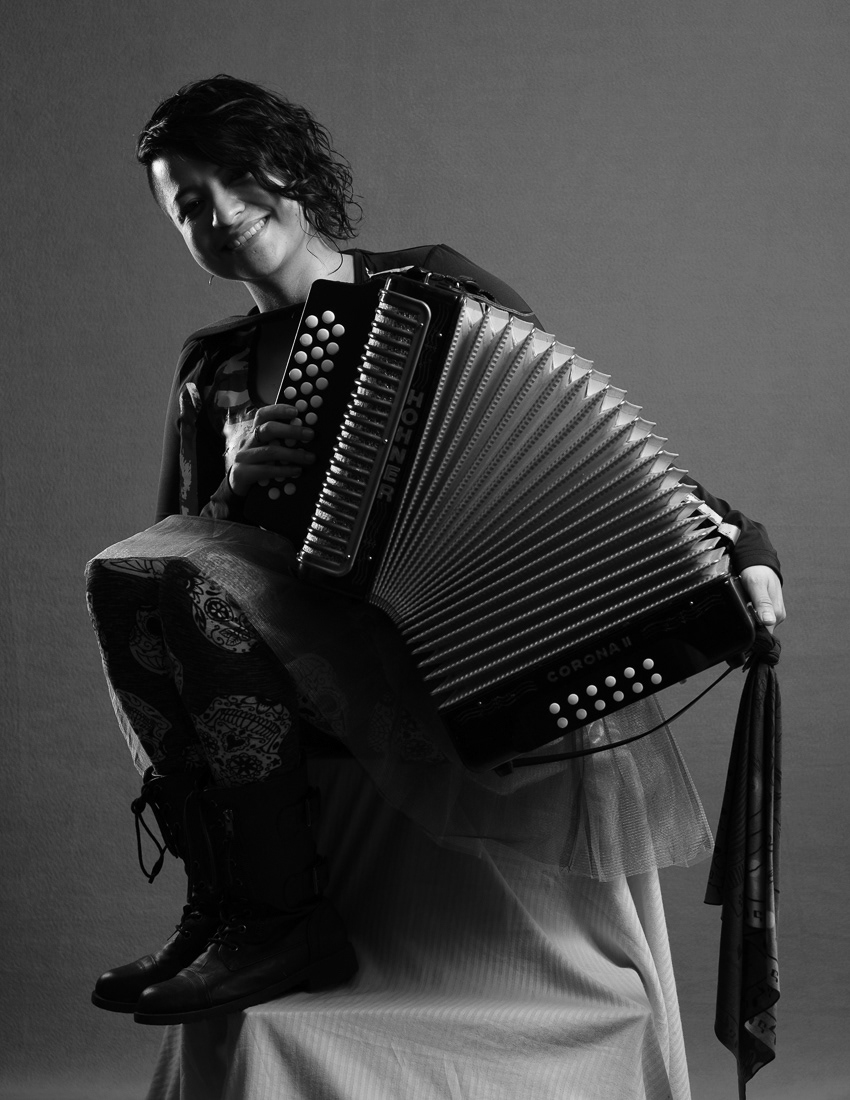 The Great Elisa: At 35 years old, Elisa De Hoyos is a wife, mother, and full-time artist on all levels with a love for crafting, acting, dancing, painting, and playing music. She is a multi-instrumentalist teaching children piano at a local music school. Along with being a teacher, she is a self-taught accordionist for three different bands; Texas Sweethearts, I Ching Gatos, and Monstruo Bohemio.
