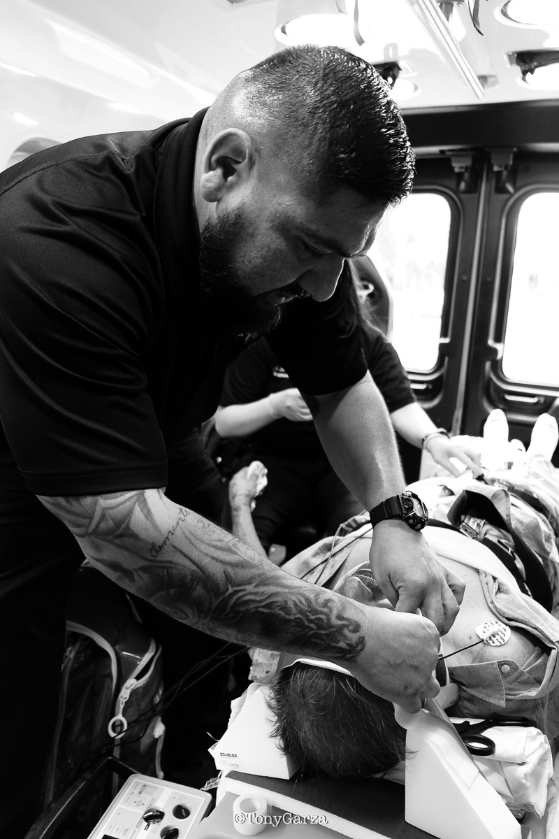 Paramedic Eric Hernandez securing and protecting the head and neck of the patient.