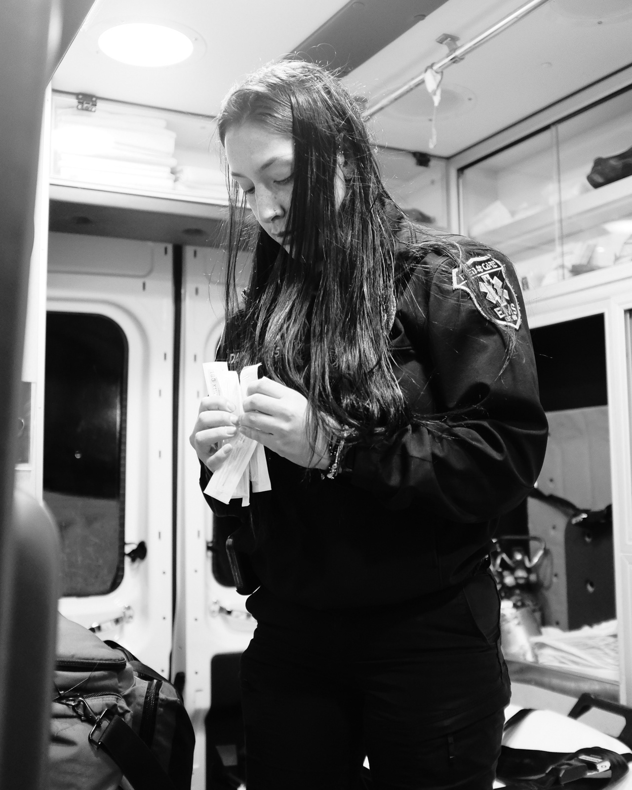 S. Davila, EMT, checks her unit, Medic 35, while she waits for her partner to arrive.