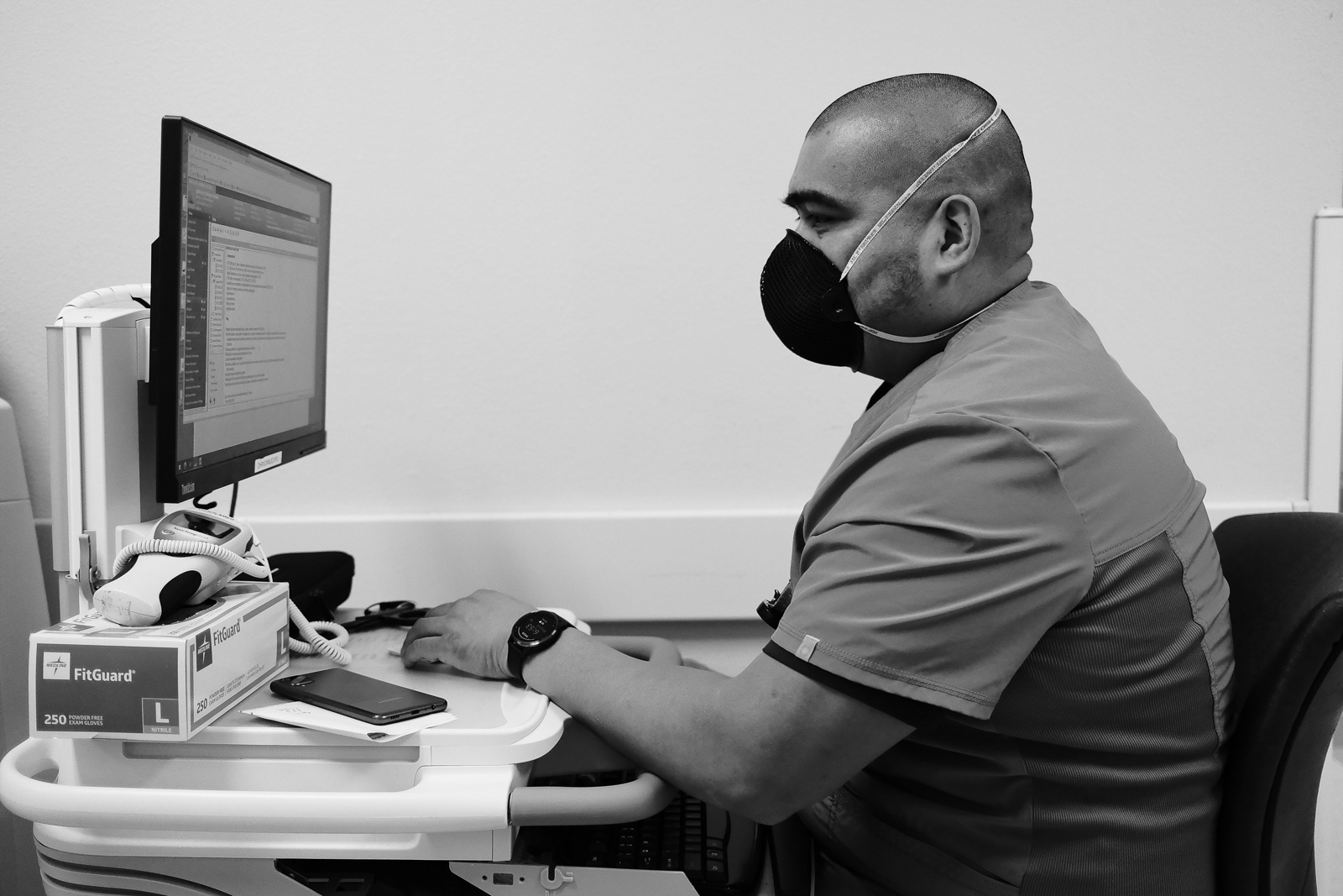 Roco, LVN, finishing up his charting at the end of his shift.