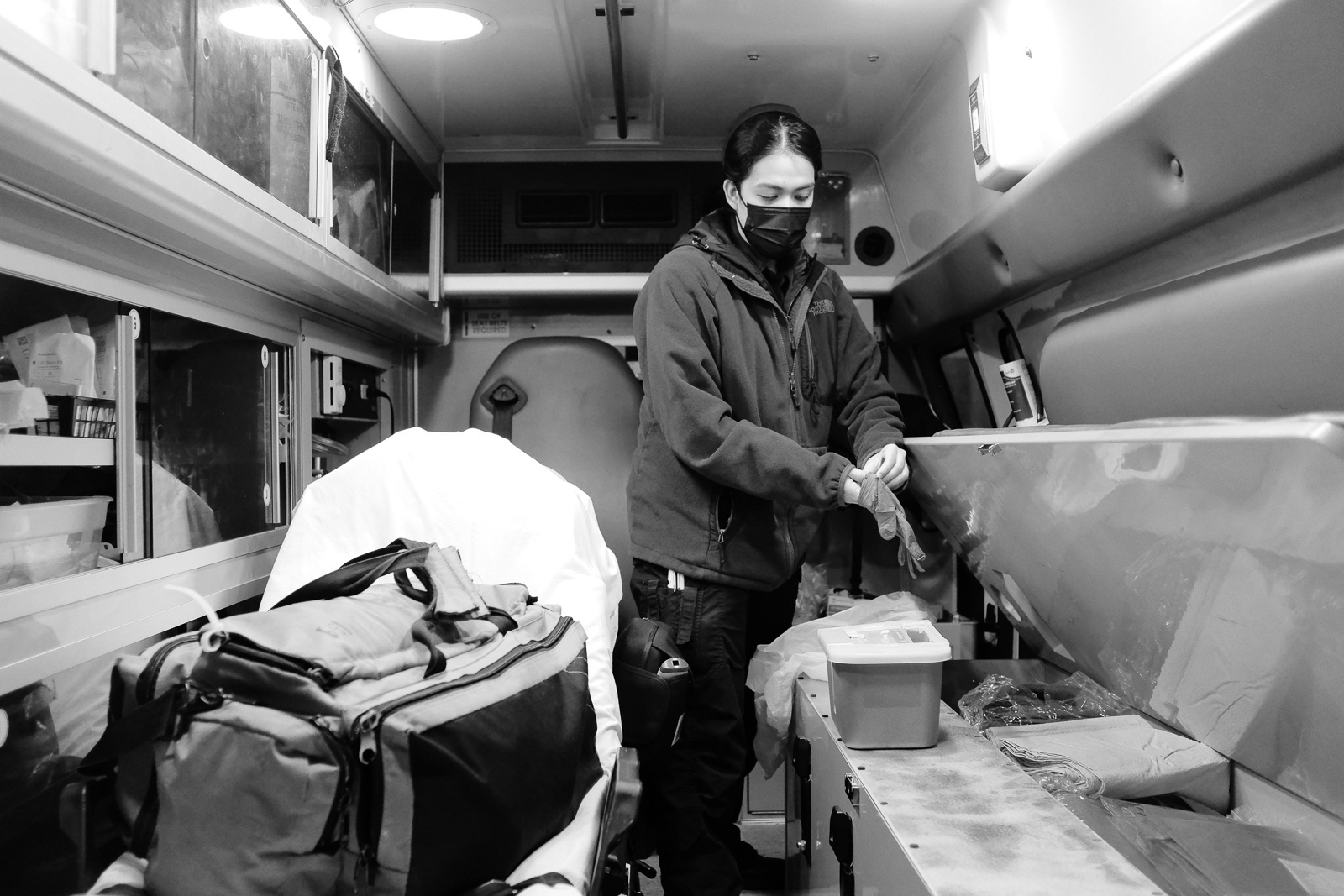 D. Lagas, EMT, puts on gloves to clean her unit before going into service at the beginning of her shift.