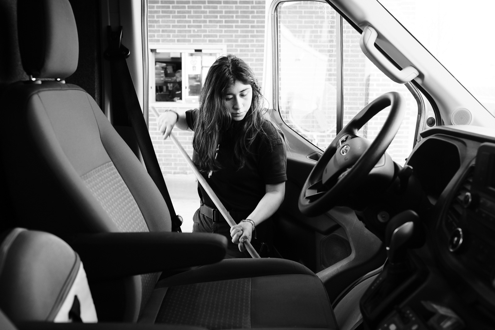 S. Perez, EMT, mops the driver seat before clocking out from her 24 hour shift.