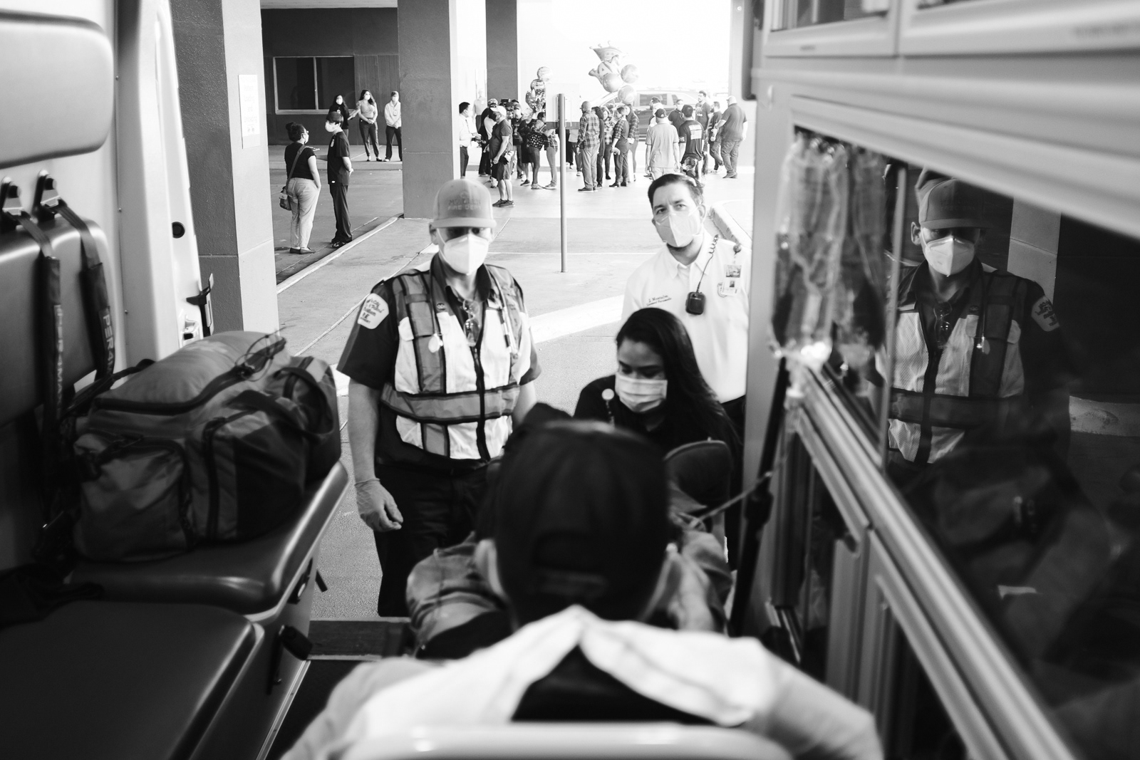 Arriving at the hospital, a group of people gather outside celebrating the discharge of a patient, who survived Covid.