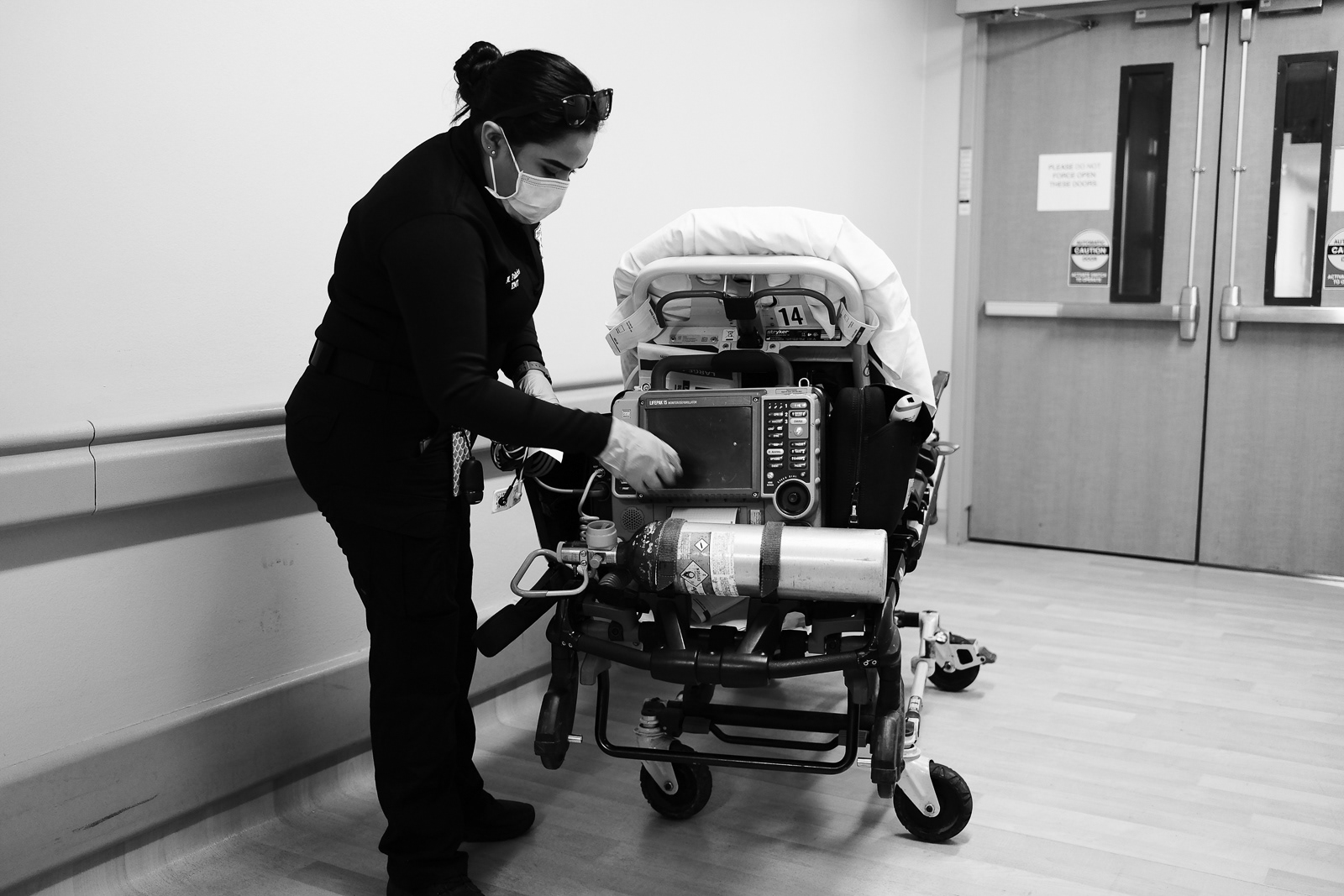 She cleans the stretcher soon after transferring the patient to their room.